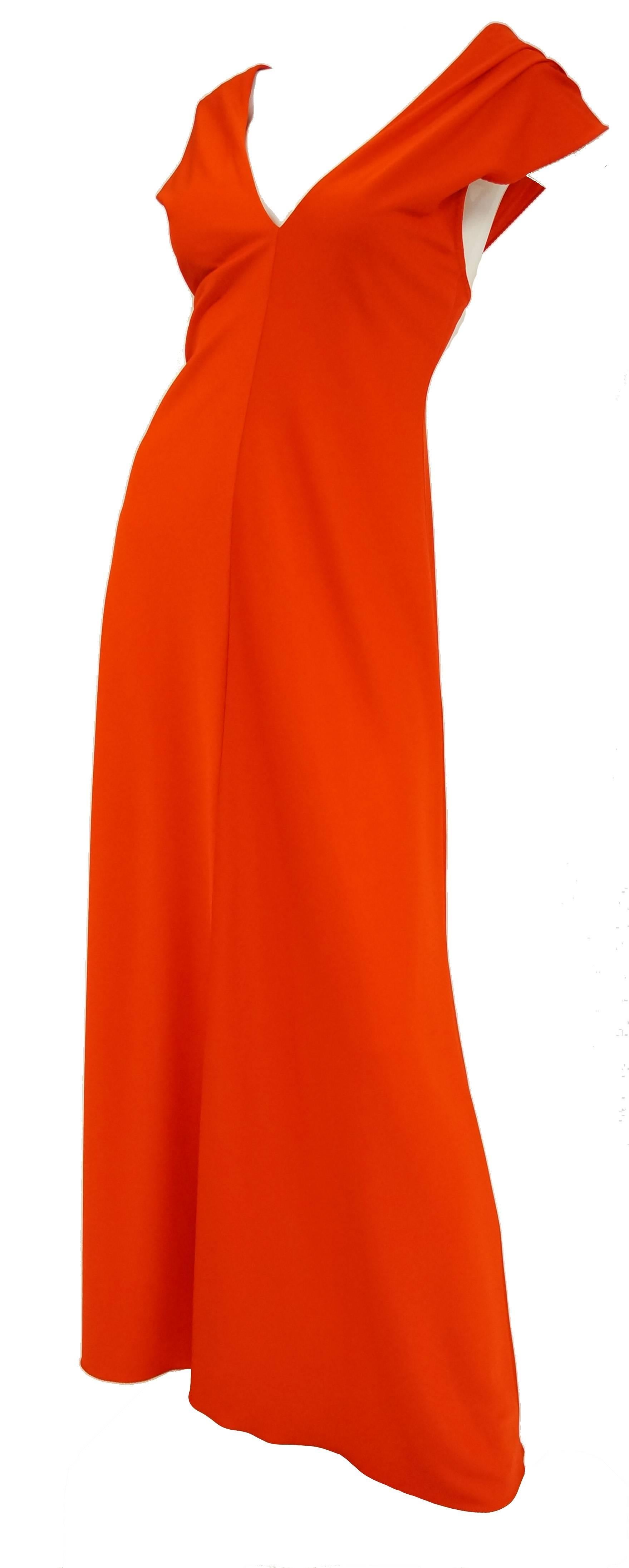 
Gorgeous! This dress is an excellent testament to Stephen Burrow’s bold use of color and distinct, dramatic draping. The floor - length dress is composed of a bright red - orange jersey knit wear fabric, and has an accent center seam running the