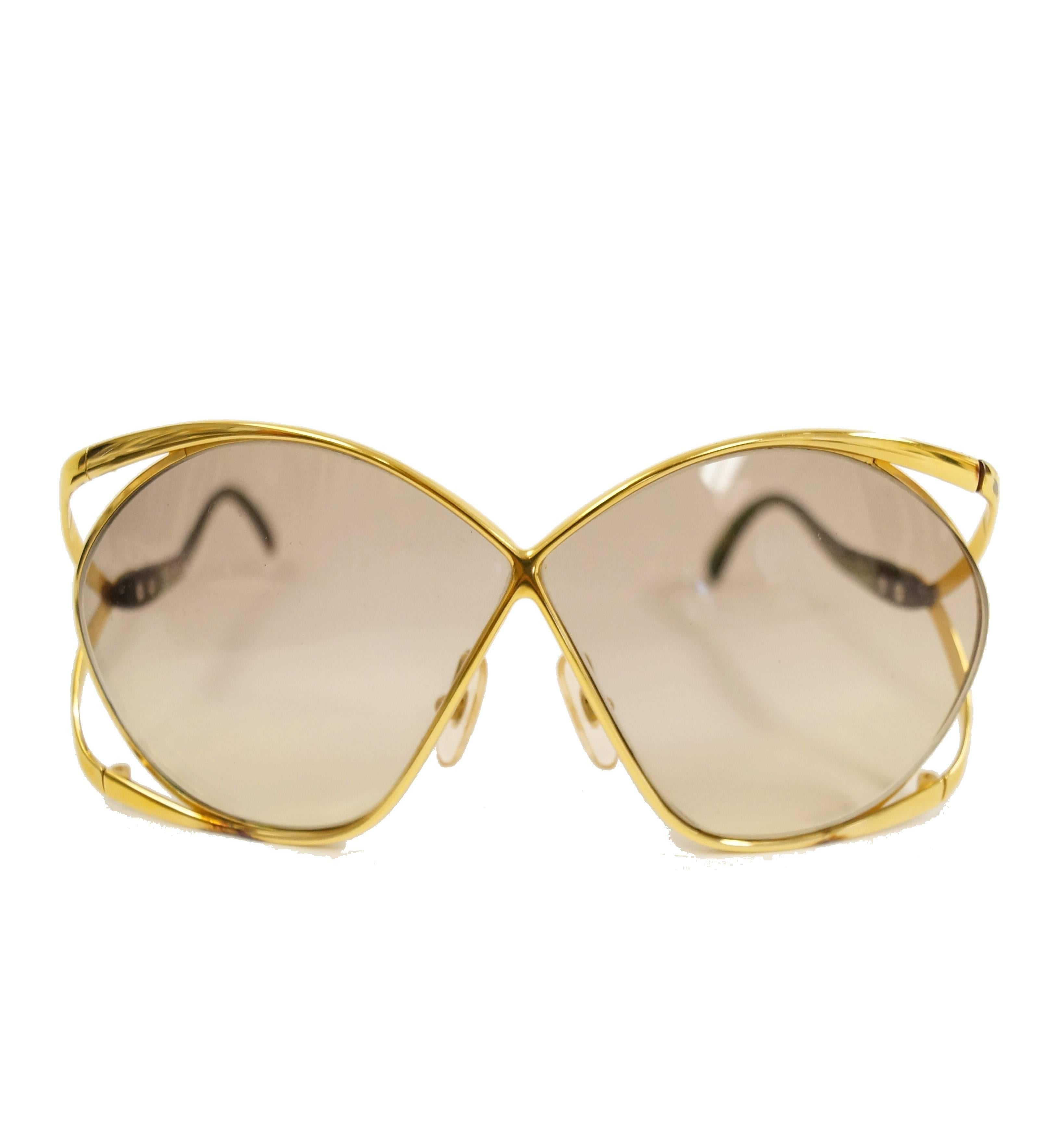 Iconic 1980s Dior butterfly sunglasses! These glamorous, feminine sunglasses showcase Dior's famous butterfly design. The apple green and gold-tone frames gently wrap around the oversized lenses. The letters 