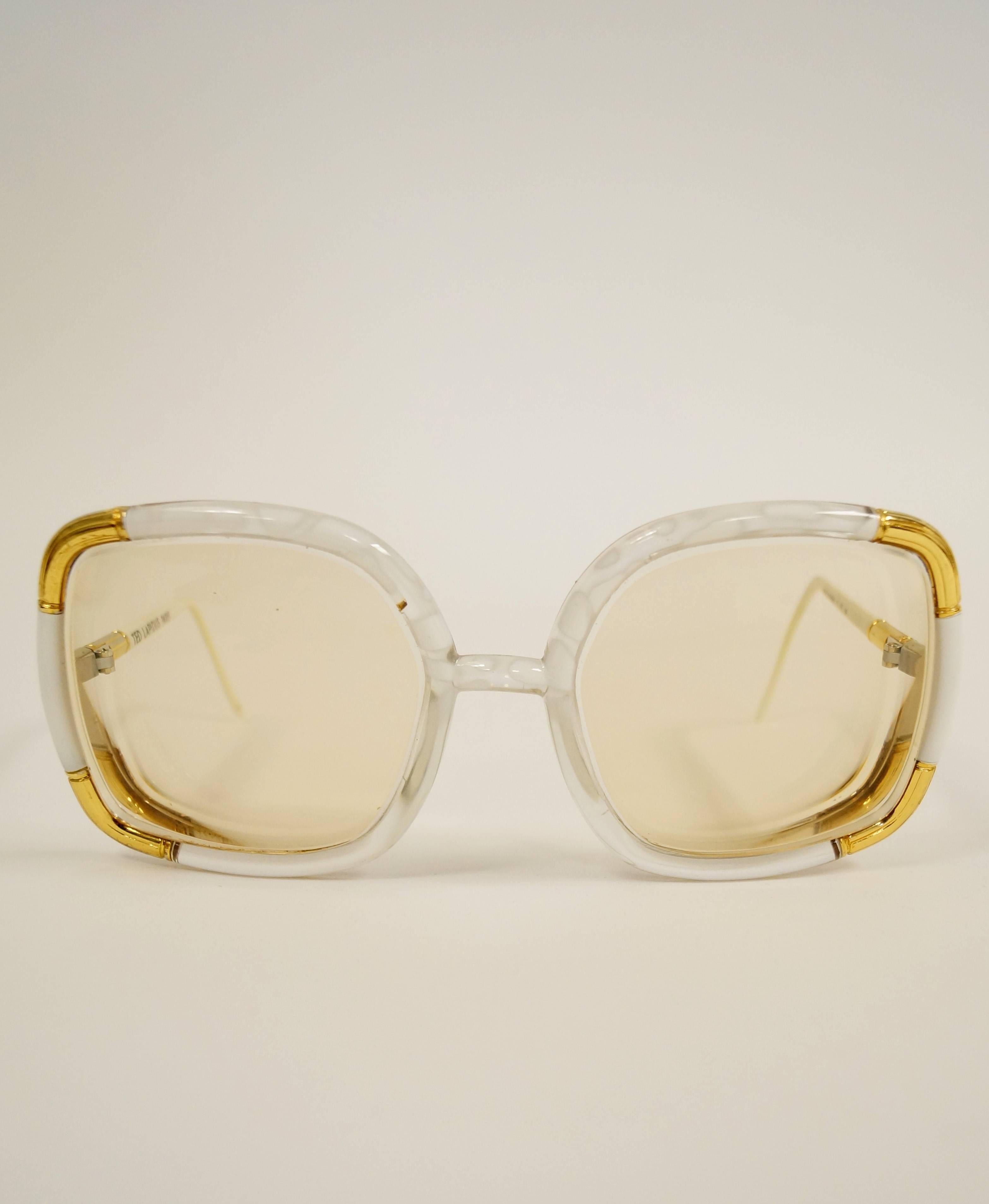 1970s Ted Lapidus Paris RX frames. These playful and vibrant oversized sunglasses are square-shaped (with a gentle rounded edge!) and feature white single bridge frames (with fantastic gold-tone accents!). The lenses have a solid amber tint, and the