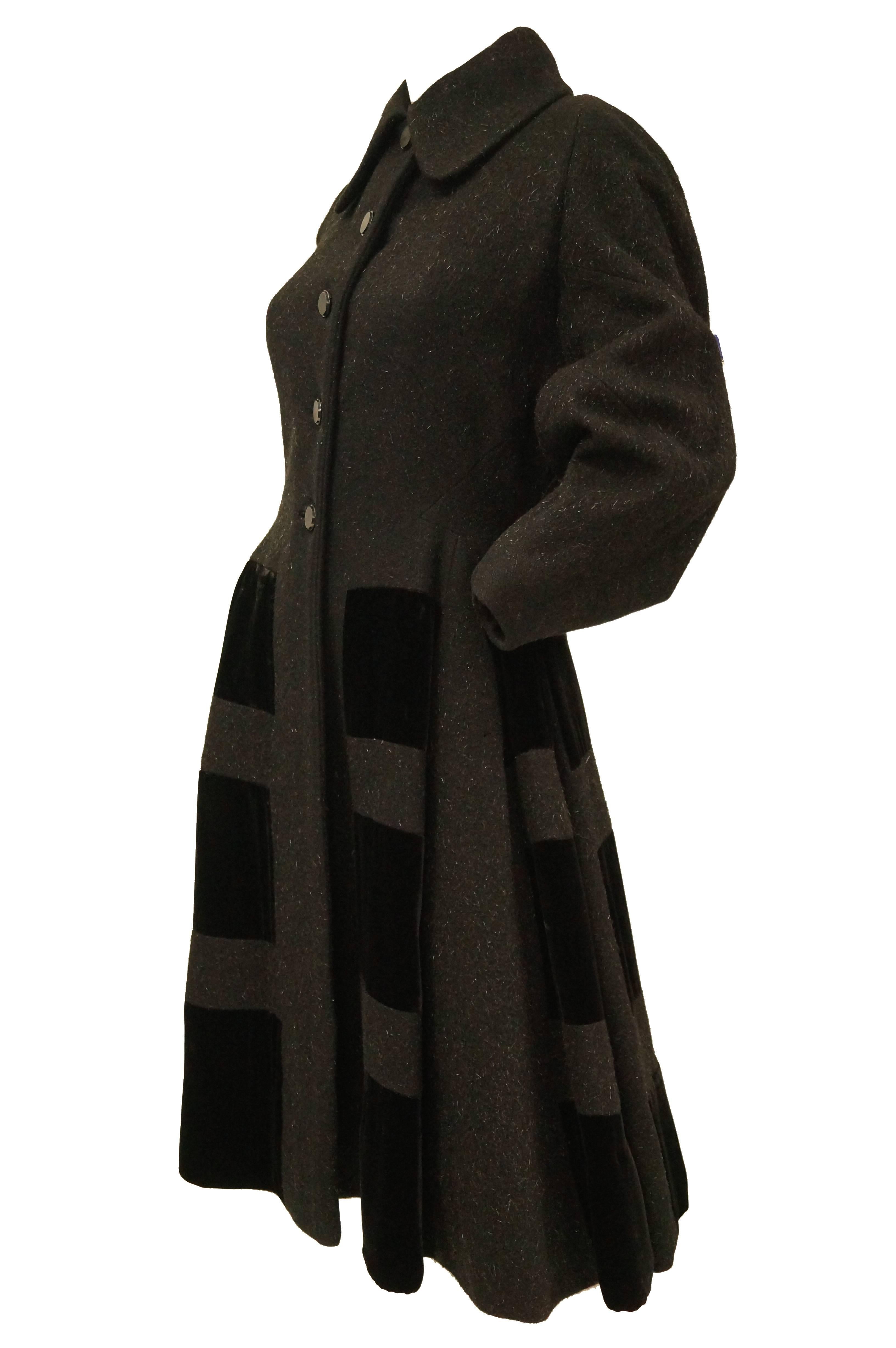 Beautiful mohair wool blend and velvet princess coat by Lilli Ann. This coat features an exaggerated arrow collar, long, cuffed sleeves, and a skirt that flares out from the narrow waist of the coat. The front of the coat features five buttons
