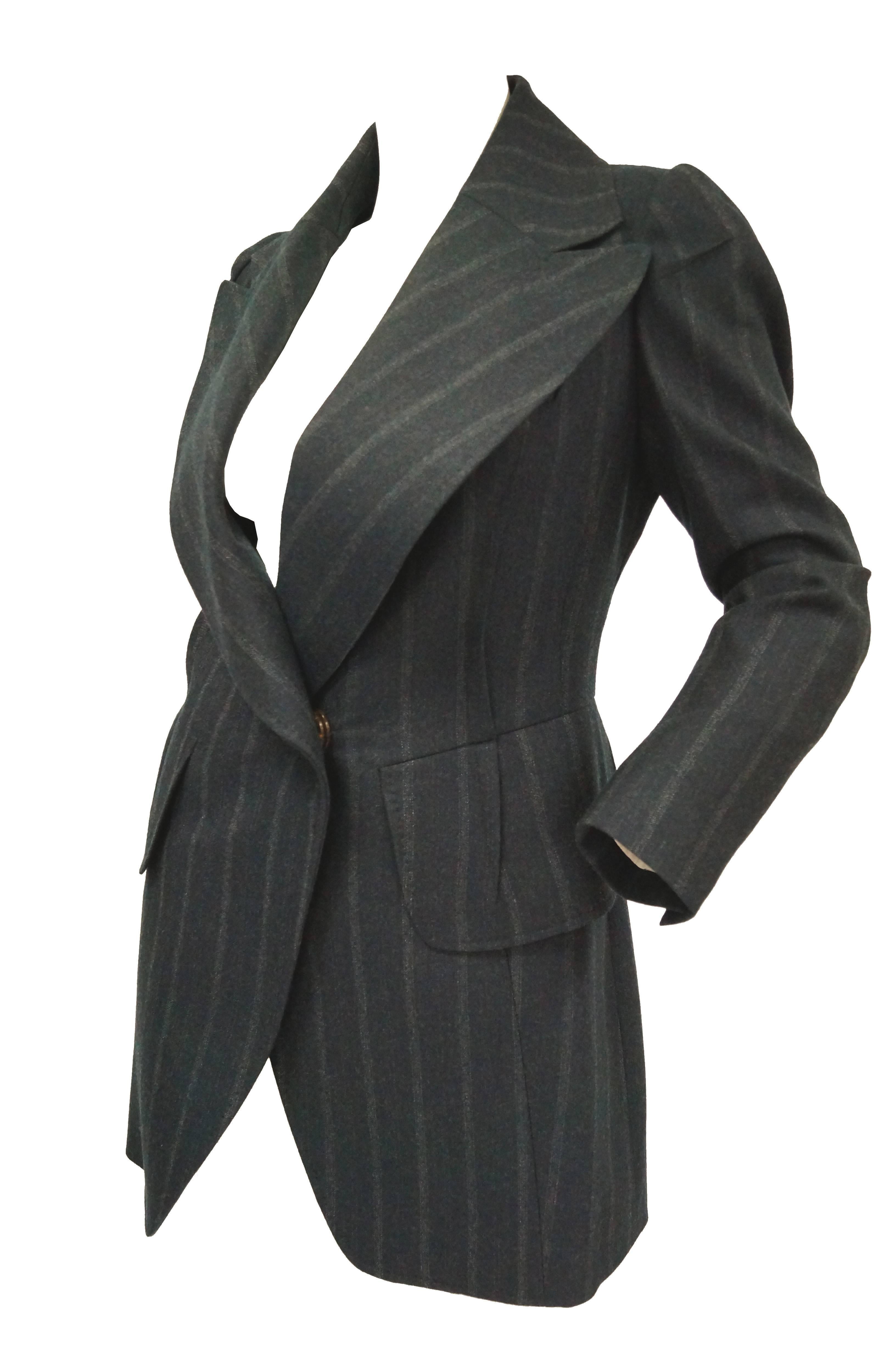 Original blank label Margiela blazer. The blazer features unique, artfully placed pleating. Pin stripes and a cinched torso accent the narrow waist of the wearer. Wide lapels and pocket flaps at the waist add drama to the not-so-classic blazer! Snap