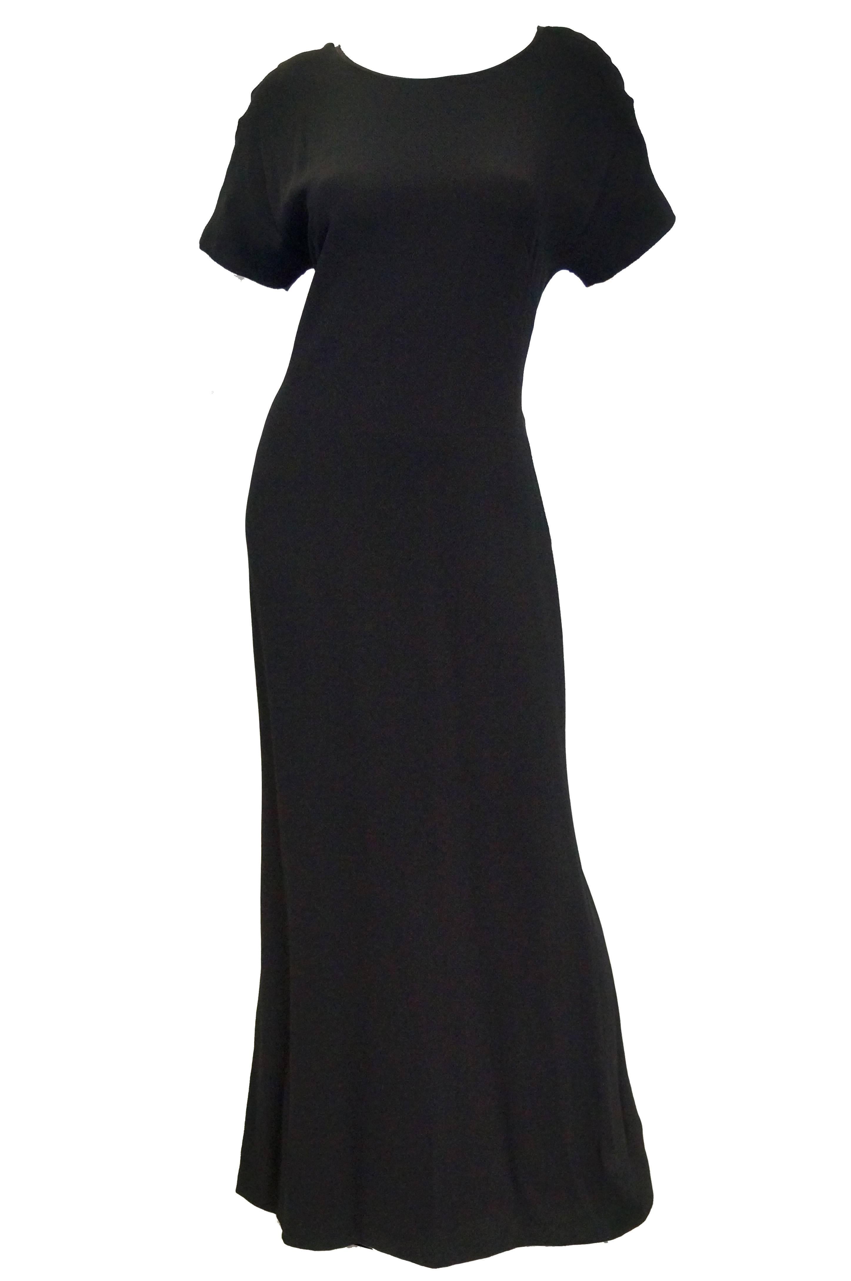 Carolina Herrera new with tags Gorgeous classic dress with a daring twist! This Carolina Herrera maxi length evening dress features a loose a - line silhouette, short sleeves ( in a very 1940s batwing cut ), a high bateau - like neckline, and an