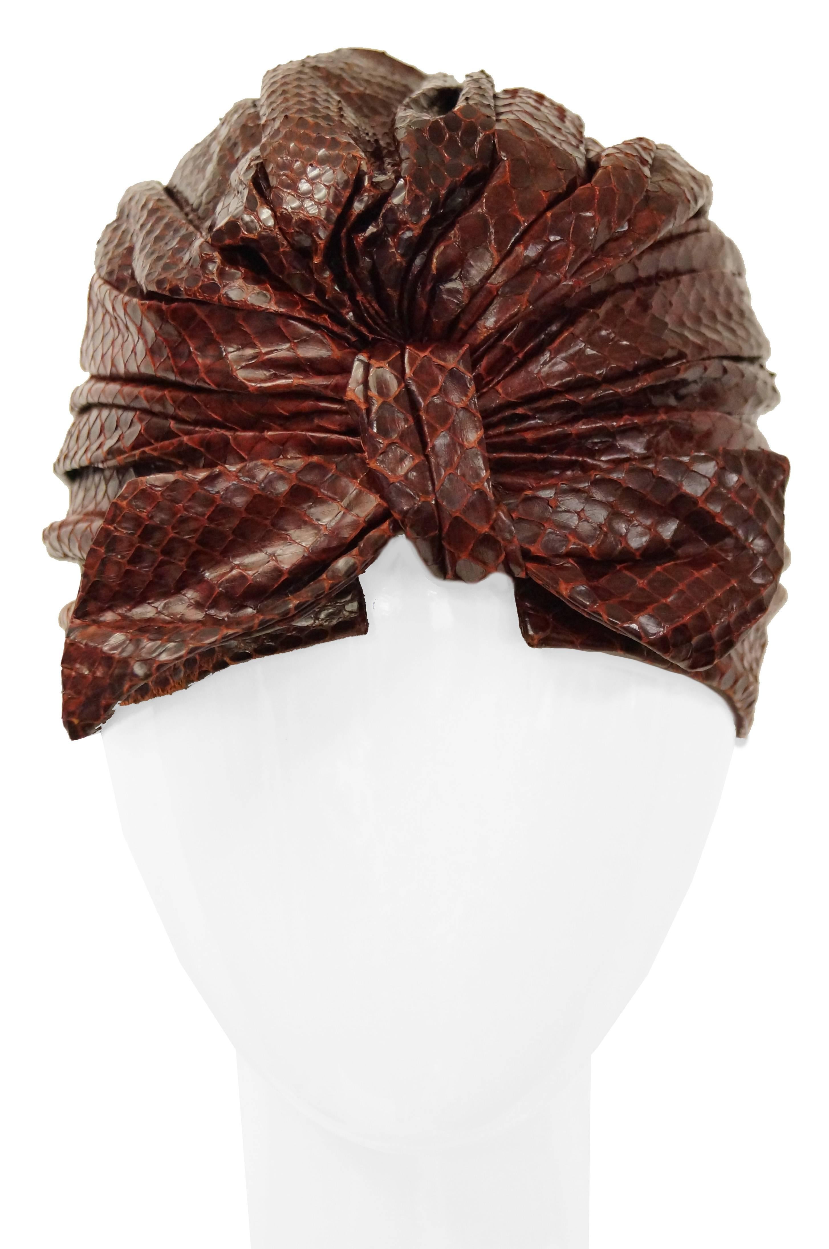 Absolutely gorgeous mid century sienna brown snakeskin turban "custom made" by the Neiman Marcus department store. The turban is made of ruched snakeskin and gathers in a bow at the back. The piece is rather versatile and can be worn