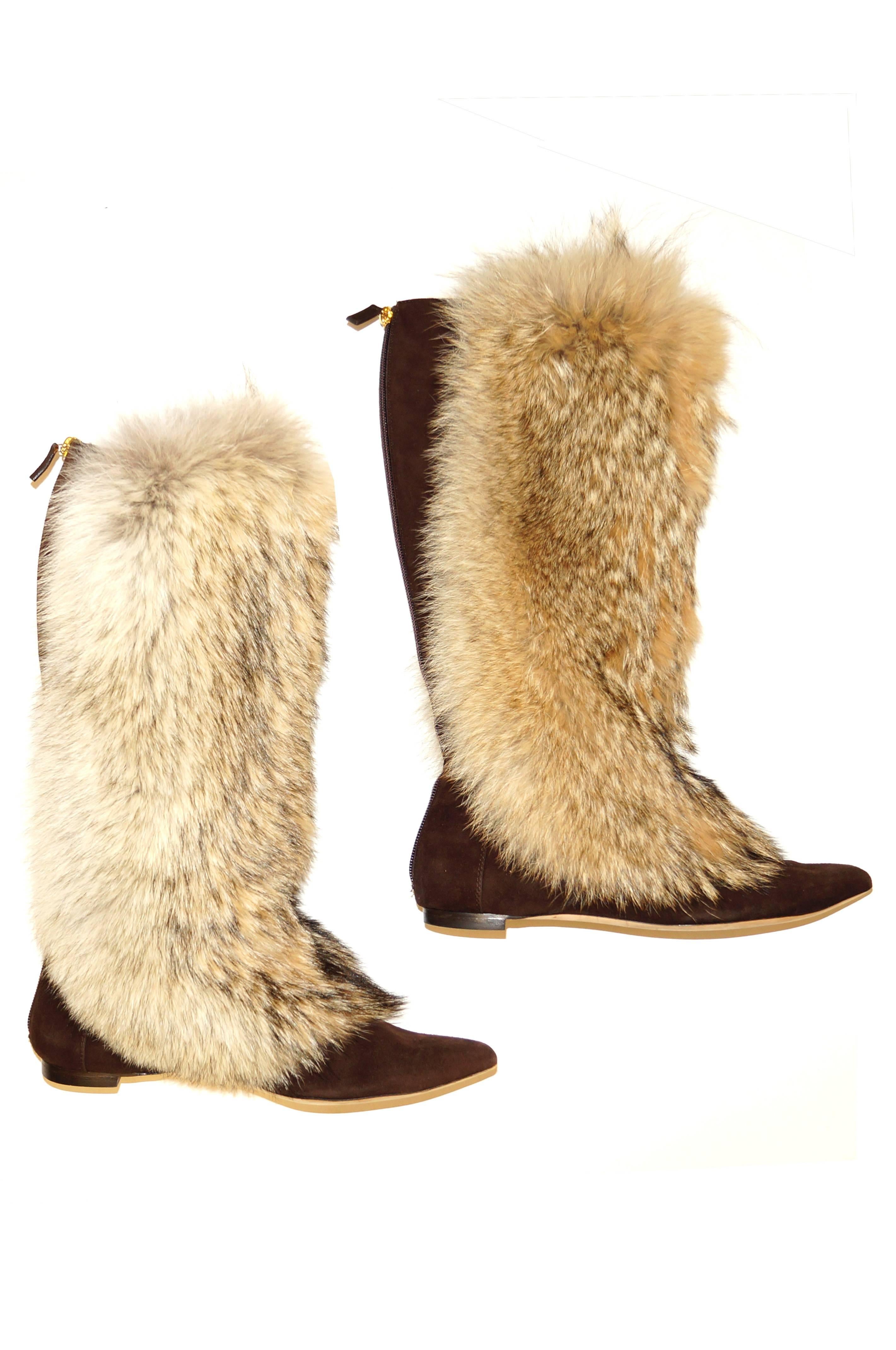 Warm, wild, and ever so wearable! These Oscar de la Renta russet brown suede boots have a lush, fluffy fur exterior covering the boot from below the knee to just past the bridge of the foot. The fur has a cream-colored base with warm grey and white