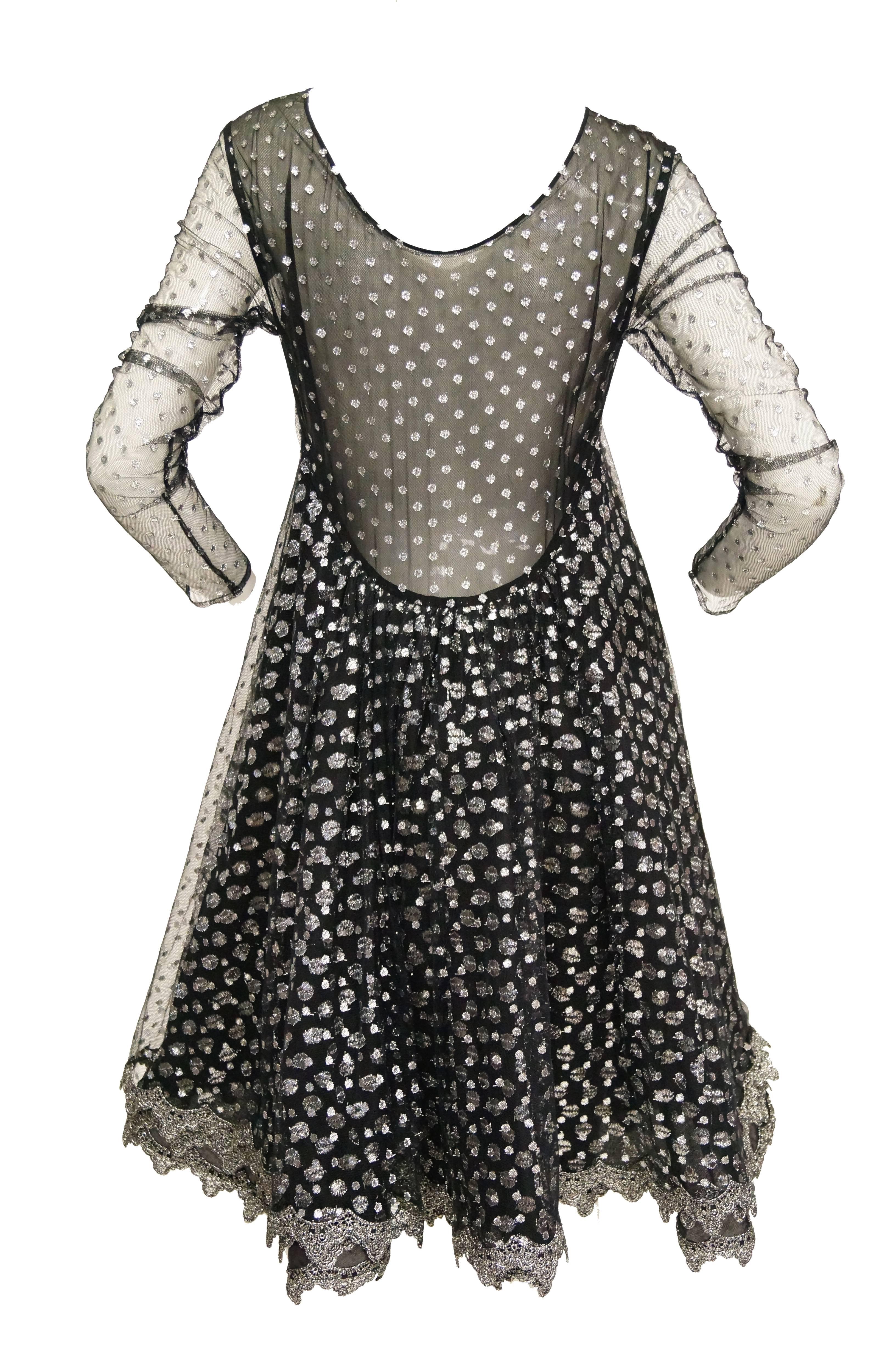 Geoffrey Beene channels the 1960s in this “MR. Beene” made in the early 1990s.  The dress has oh such wonderful movement and shine! 

Two layeers of silver metallic polka dotted tulle, one smaller dots than the other. Sheer sleeves. Attached sewn in