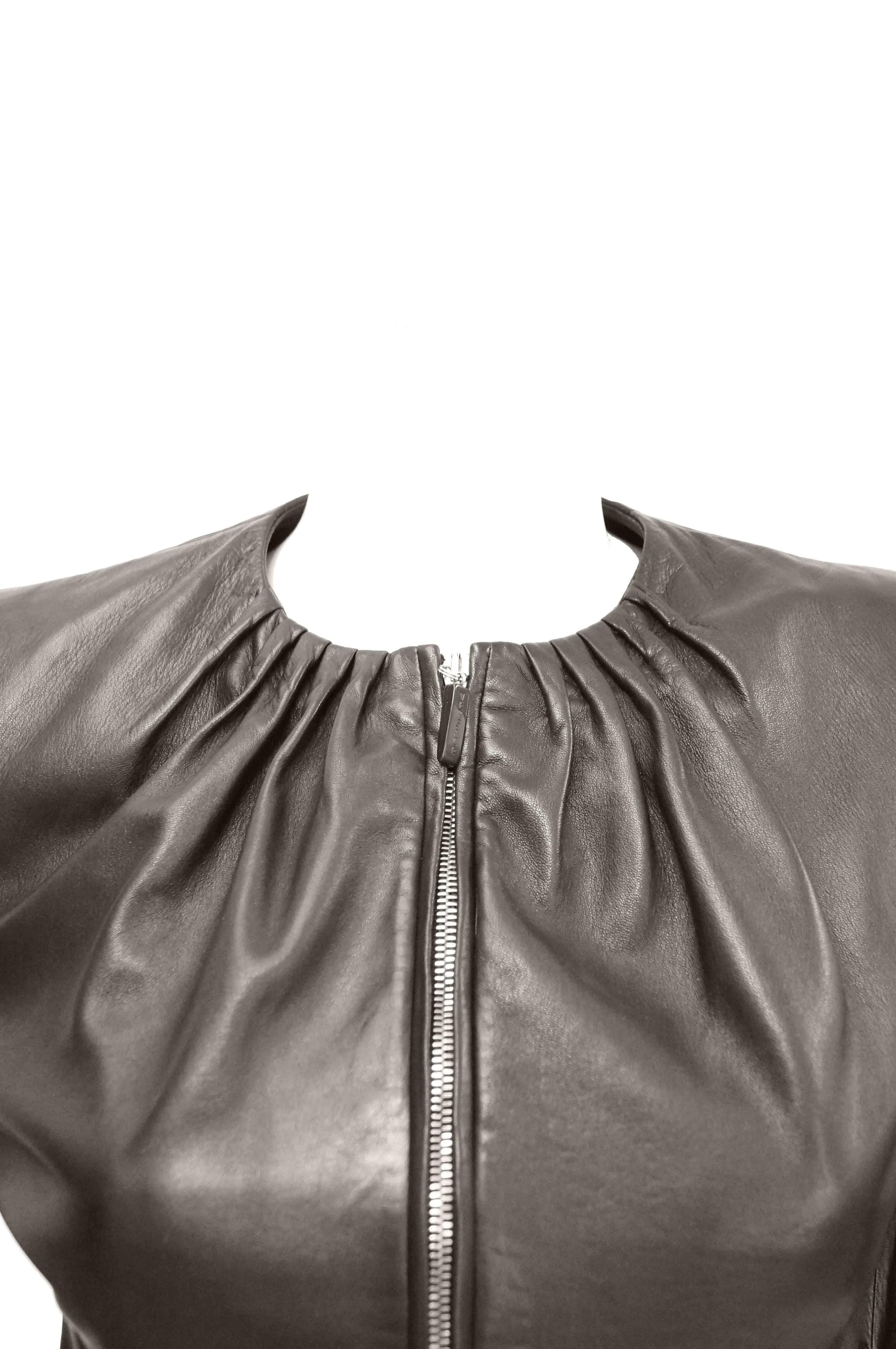 Beautiful, soft, buttery leather kidskin jacket by Versace. The jacket is hip length, with long, slim sleeves, and a high neckline. The beautiful jewel neckline has small, gathered pleats at the collar. The jacket features two triangular panels at