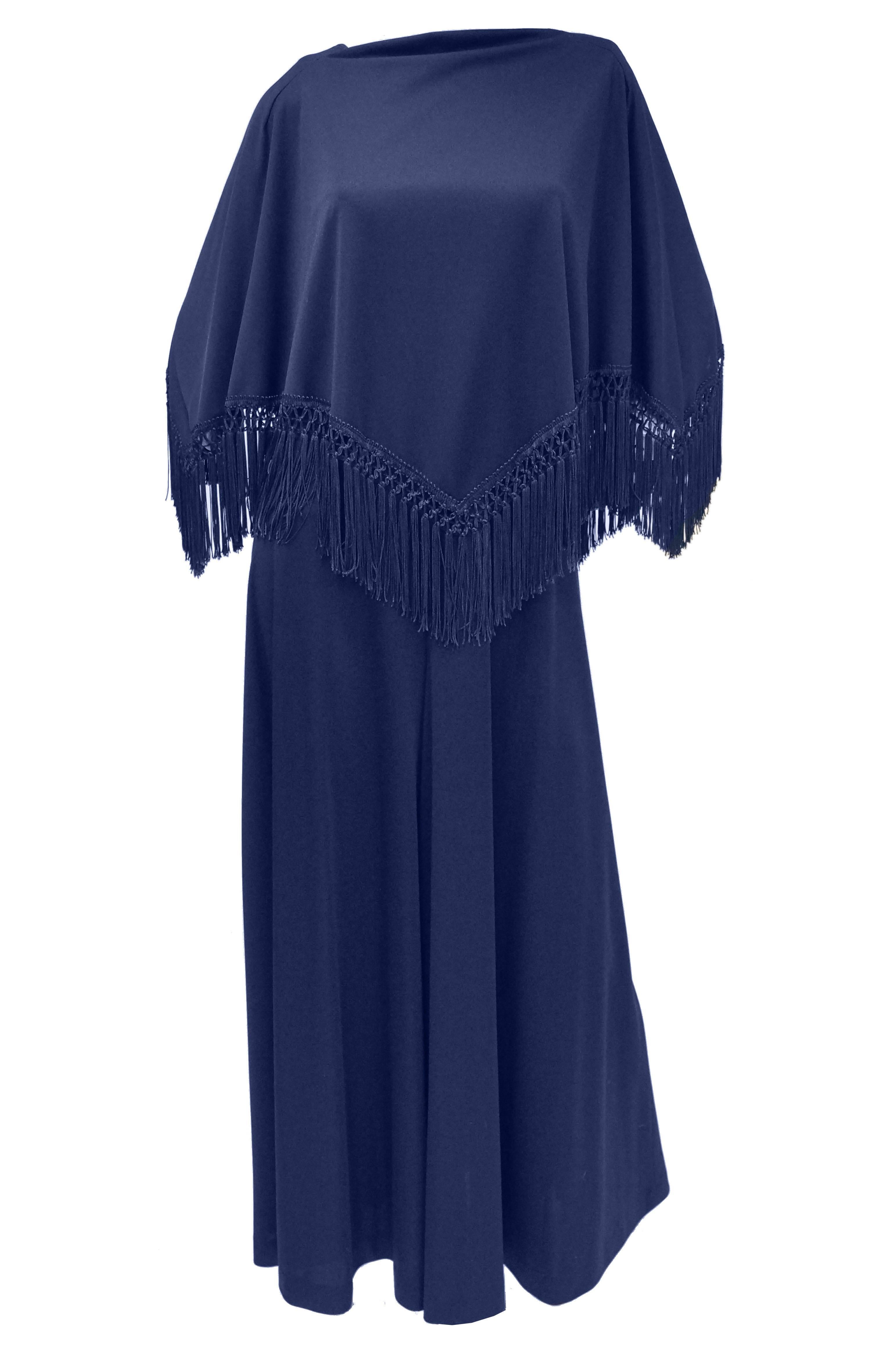 Deep indigo jumpsuit with fabulous shawl top! The jumpsuit features a loose silhouette 
layered under a shawl. The jumpsuit is sleeveless with a jewel neckline, and has voluminous floor length palazzo pants that sway gently when walking. The most