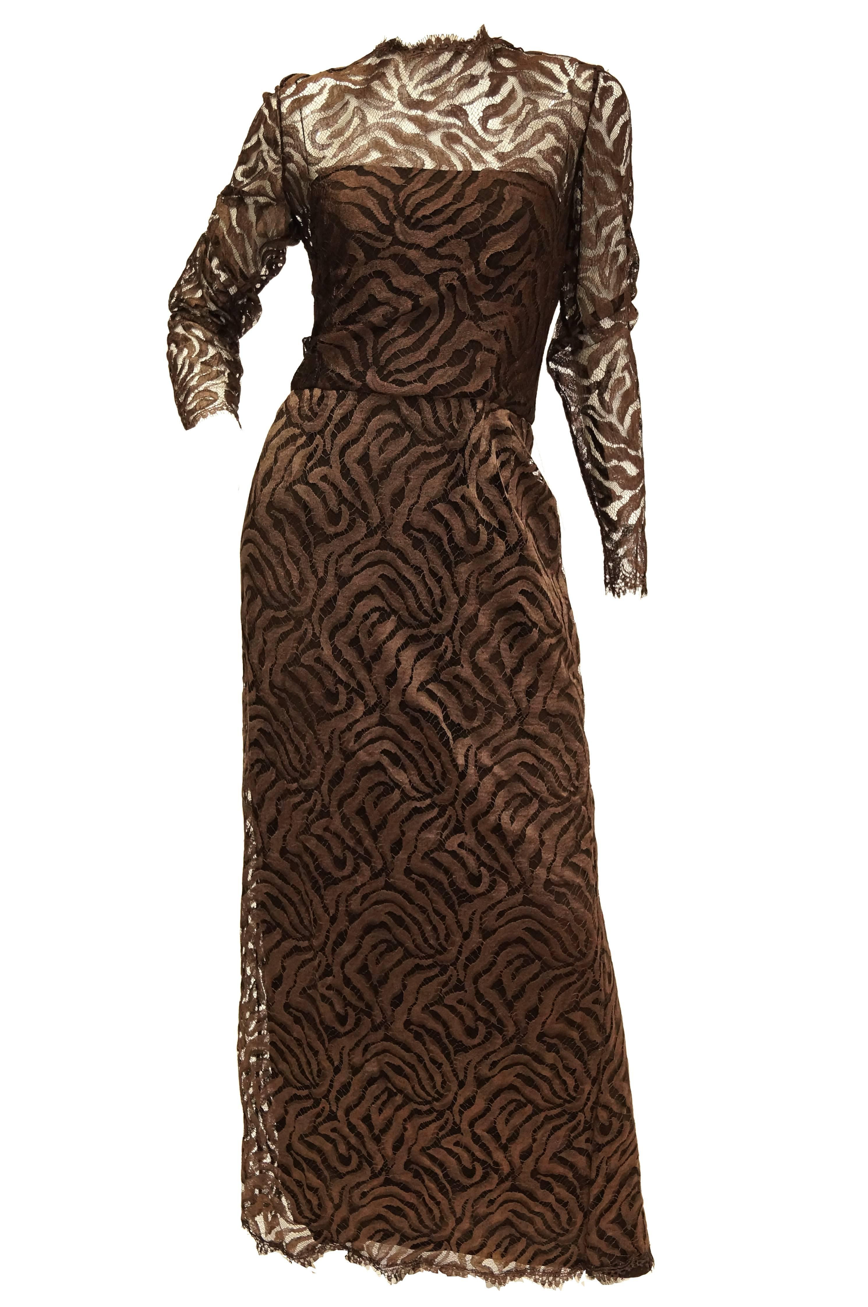 Elegant floor length maxi dress by Stanley Platos Martin Ross. The Dress features long sleeves and a slip - like layering dress. The bottom layer of the dress is brown, floor length, and sleeveless, with a straight - across neckline. The top layer