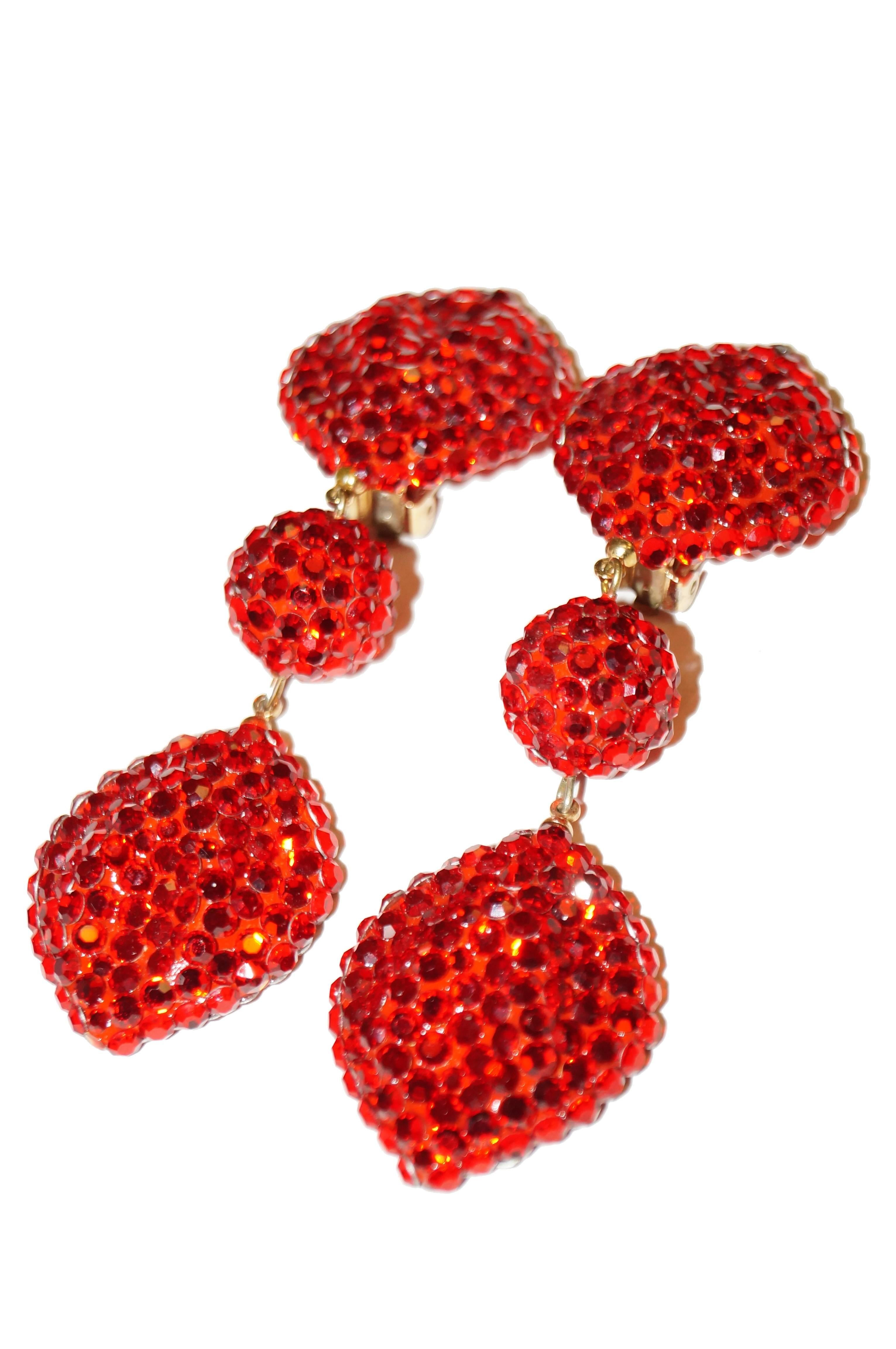 Radiant vintage Richard Kerr earrings. These dangle earrings are composed of three bright red segments covered in rhinestones. The top and bottom segments are oval shaped with pointed tips, the center segment is a sphere. Center and bottom segments