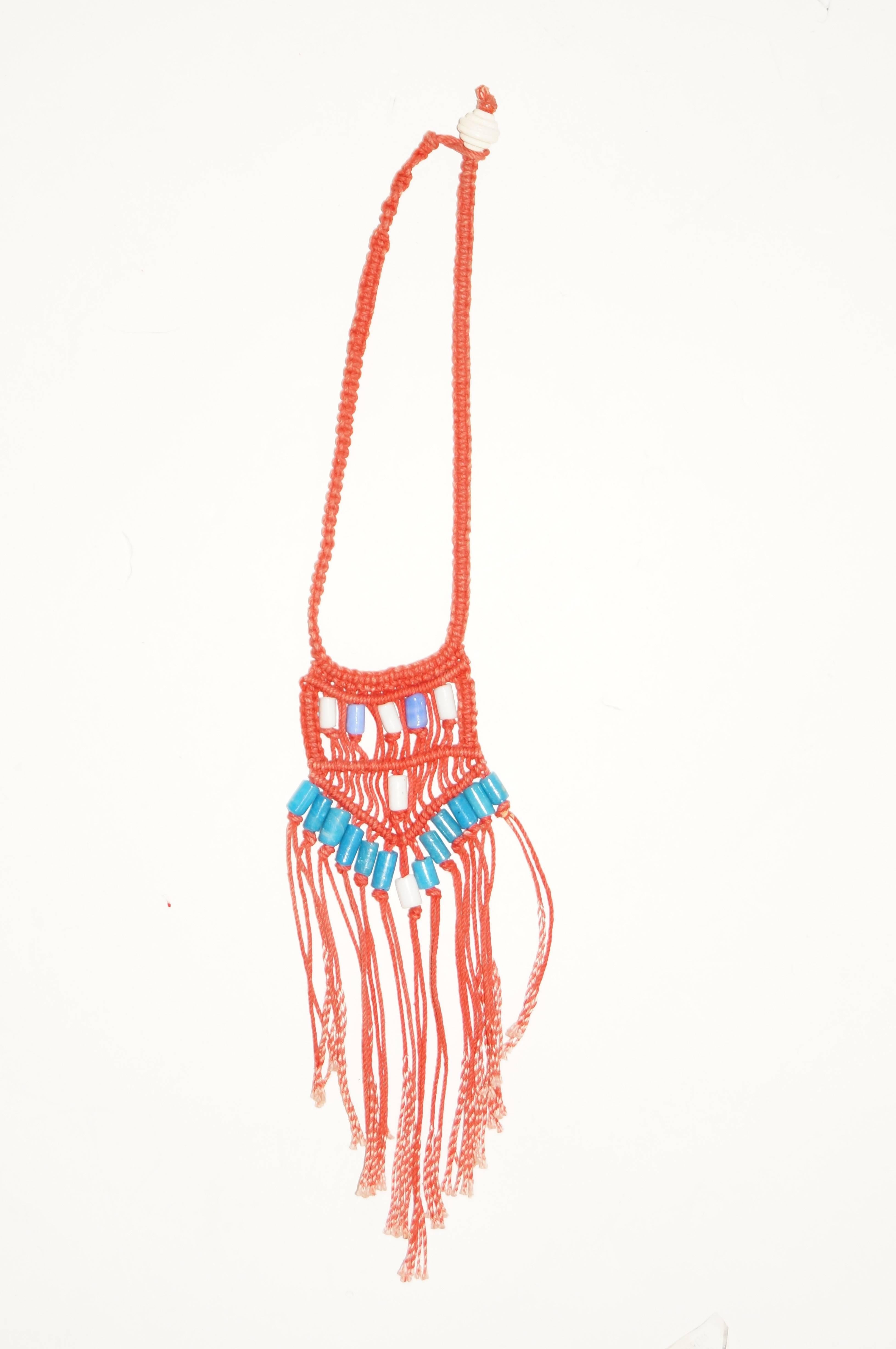 Custom red macrame boho necklace with blue ceramic beading and tassels. White wood bead at loop closure.

18" neck
9' Length