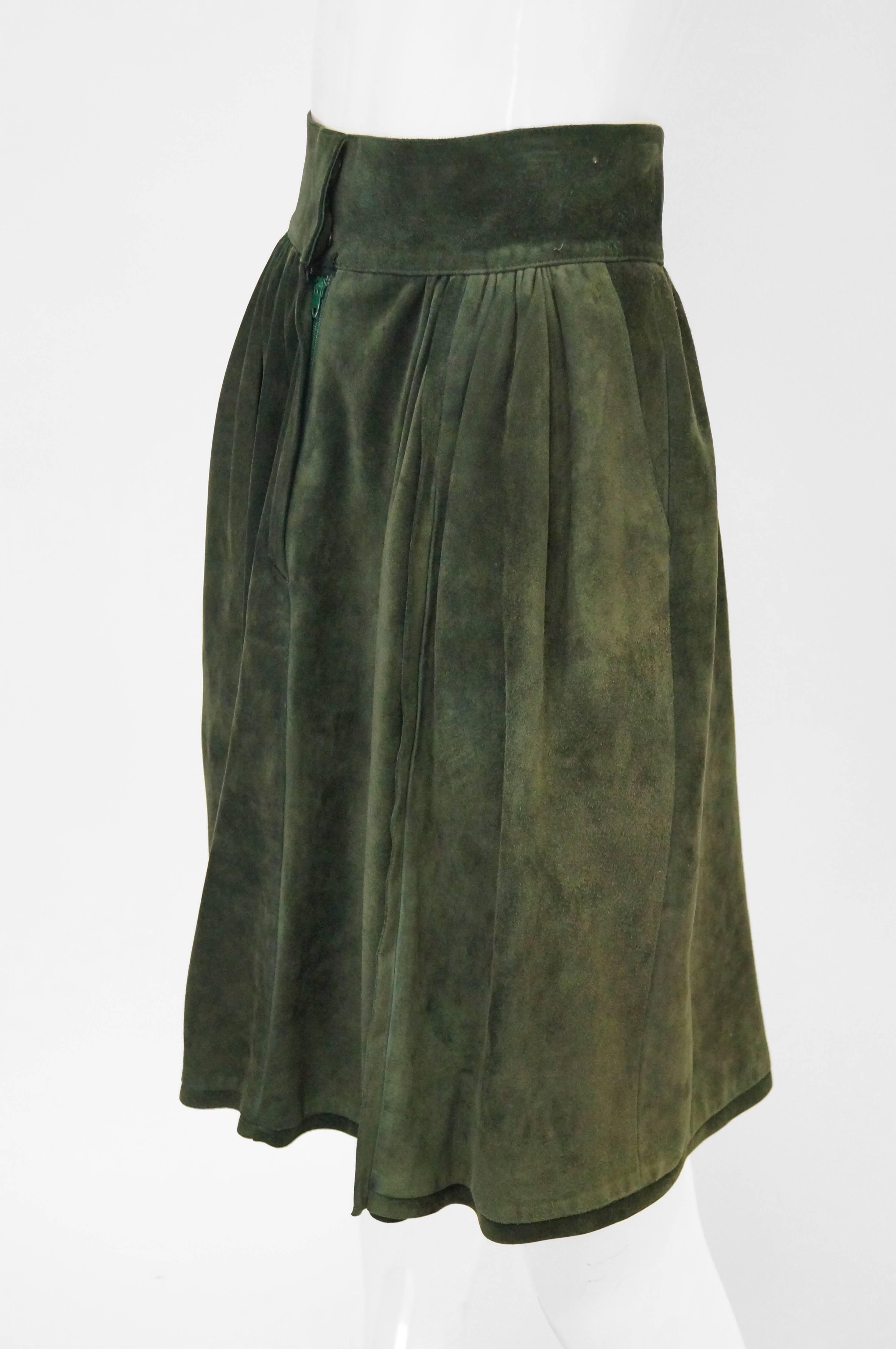 Green suede symmetrically pleated Mario Valentino skirt. Skirt is knee length, with a wide waist band, and zipper closure. Has pockets hidden in the pleats! Made in Italy.