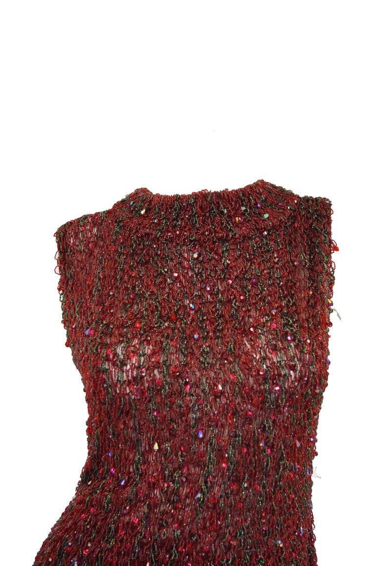 Historically significant 1963 Yves Saint Laurent garnet red couture beaded evening ensemble. This two piece midi skirt and top ensemble was acquired from the estate of Claudette Colbert, preeminent  Hollywood Golden Age leading lady. The ensemble