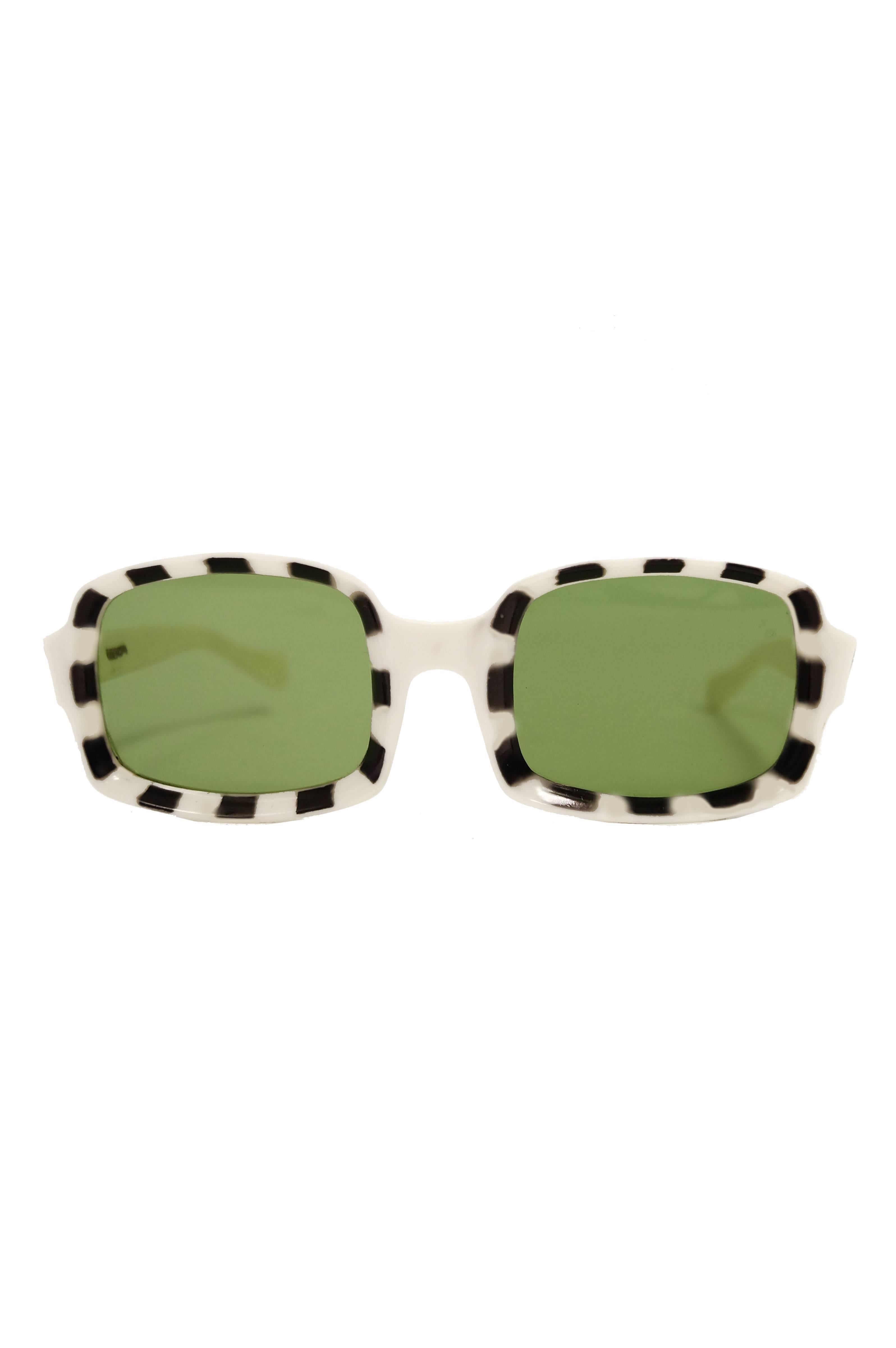 Amazing white and black frame Italian mod glasses. These authentic 1960s glasses feature rectangular green lenses with black and white checkered frames. The angular shape of the glasses is a fantastic, original take on mod frames, which are usually