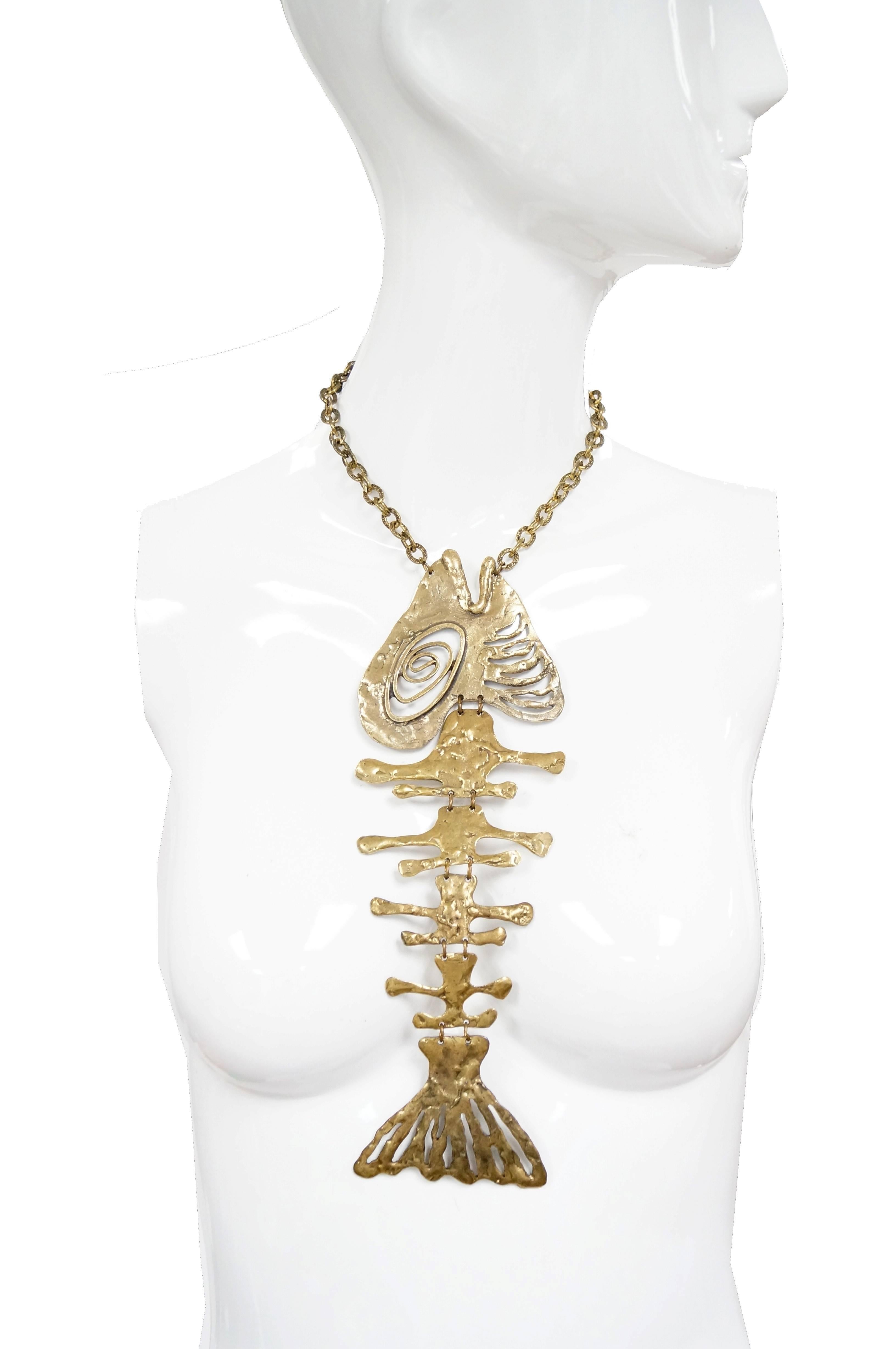 Extremely Rare Louis Giusti semi-articulated fish bone necklace. This unusual mid century statement piece features a detailed tail, gills, and swirling eye. Wonderful brutalist design with unexpected whimsical elements. Fish hangs on a heavy,