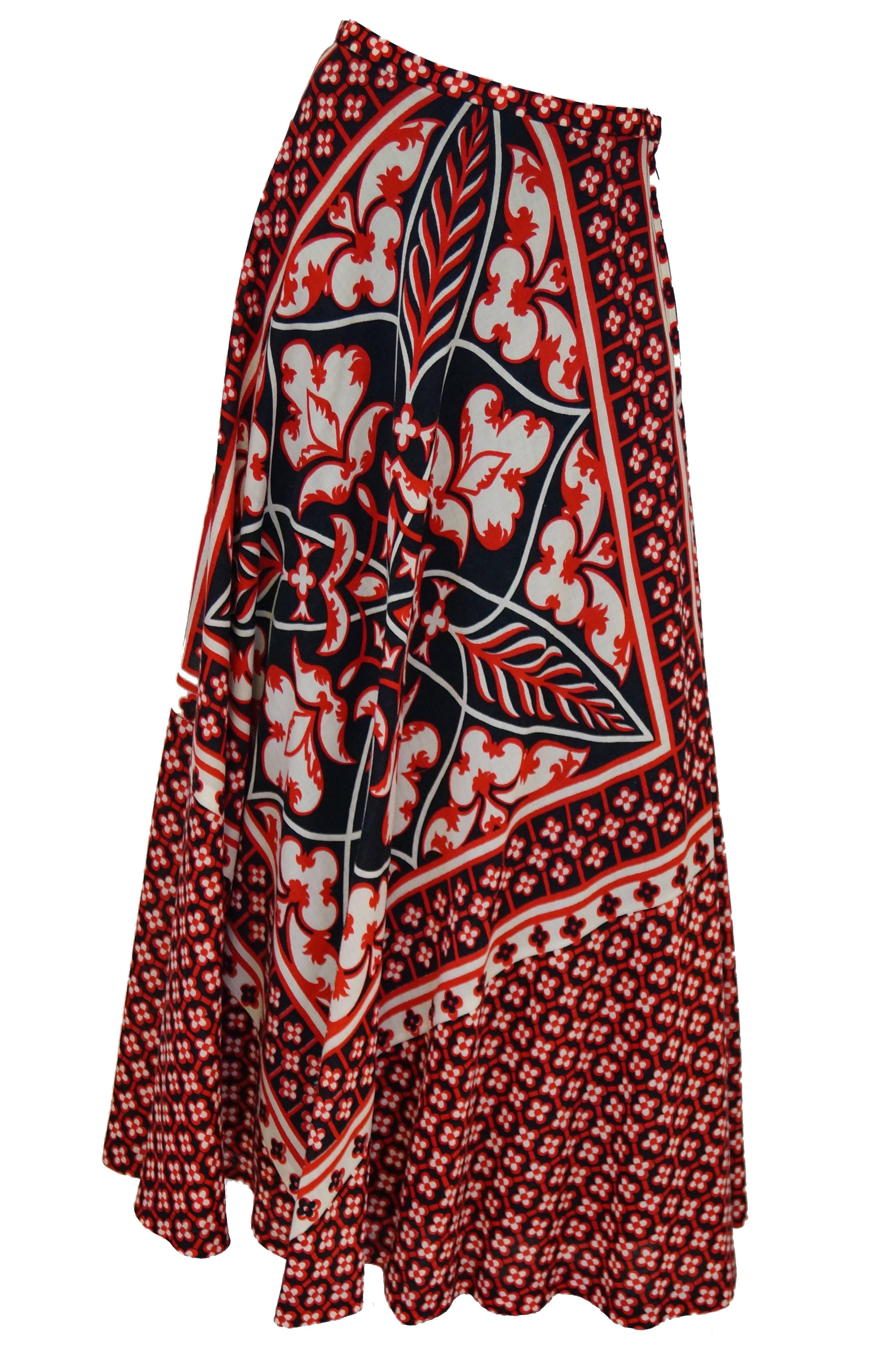 Red, black and white graphic print woven wool maxi skirt. The front of the skirt has a large placement print motif while the back is a symmetrical repeat pattern similar to the Dior flower print of the 60's. The wool fabric is woven and bias cut.