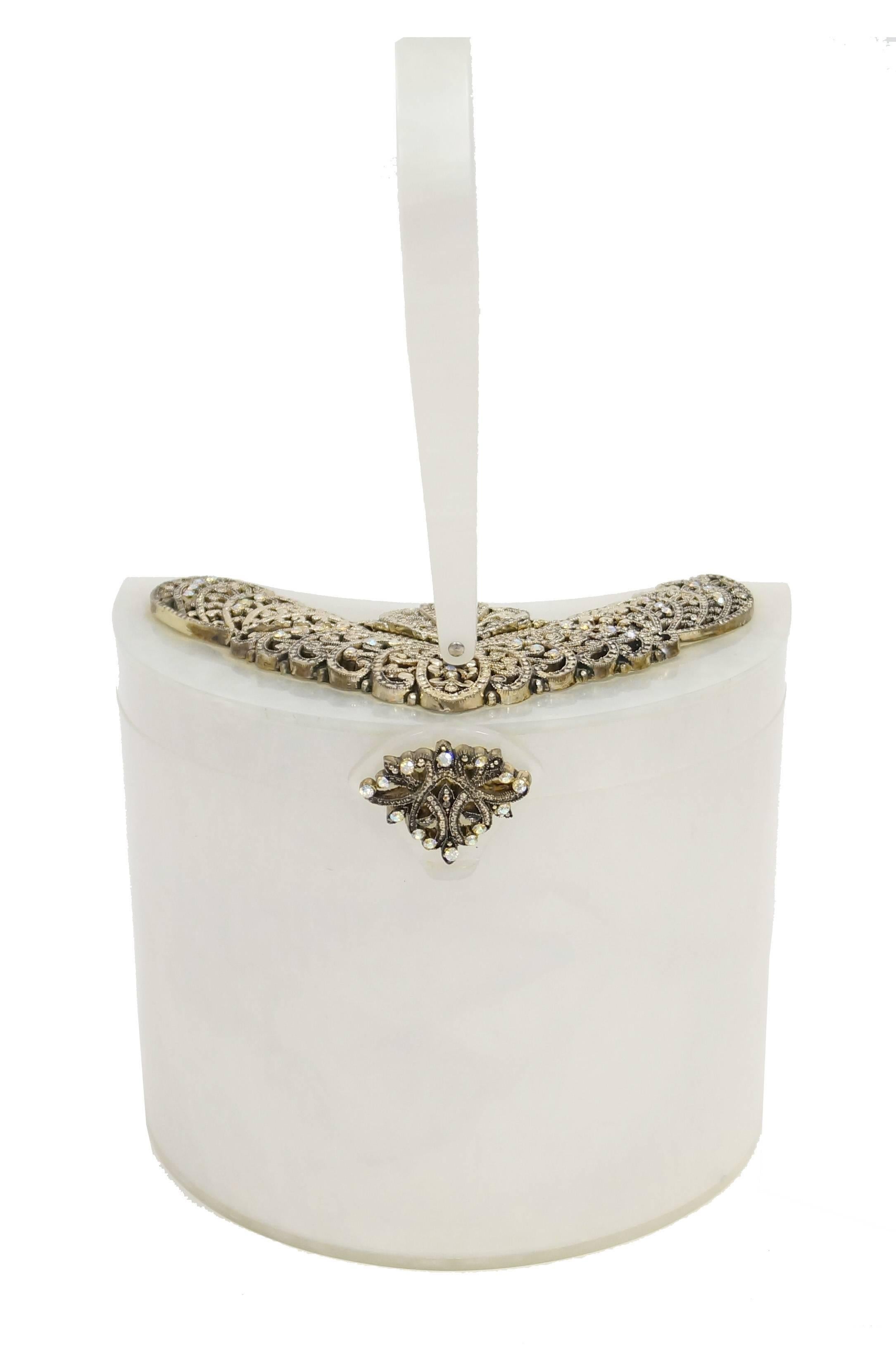 Gorgeous 1950s Wilardy Half Moon Pearlescent Lucite Box Purse.  This purse features a crescent - shaped body, with structured loop handle, and shallow lid. The lid and clasp are  detailed with metalwork featuring floral flourishes and iridescent