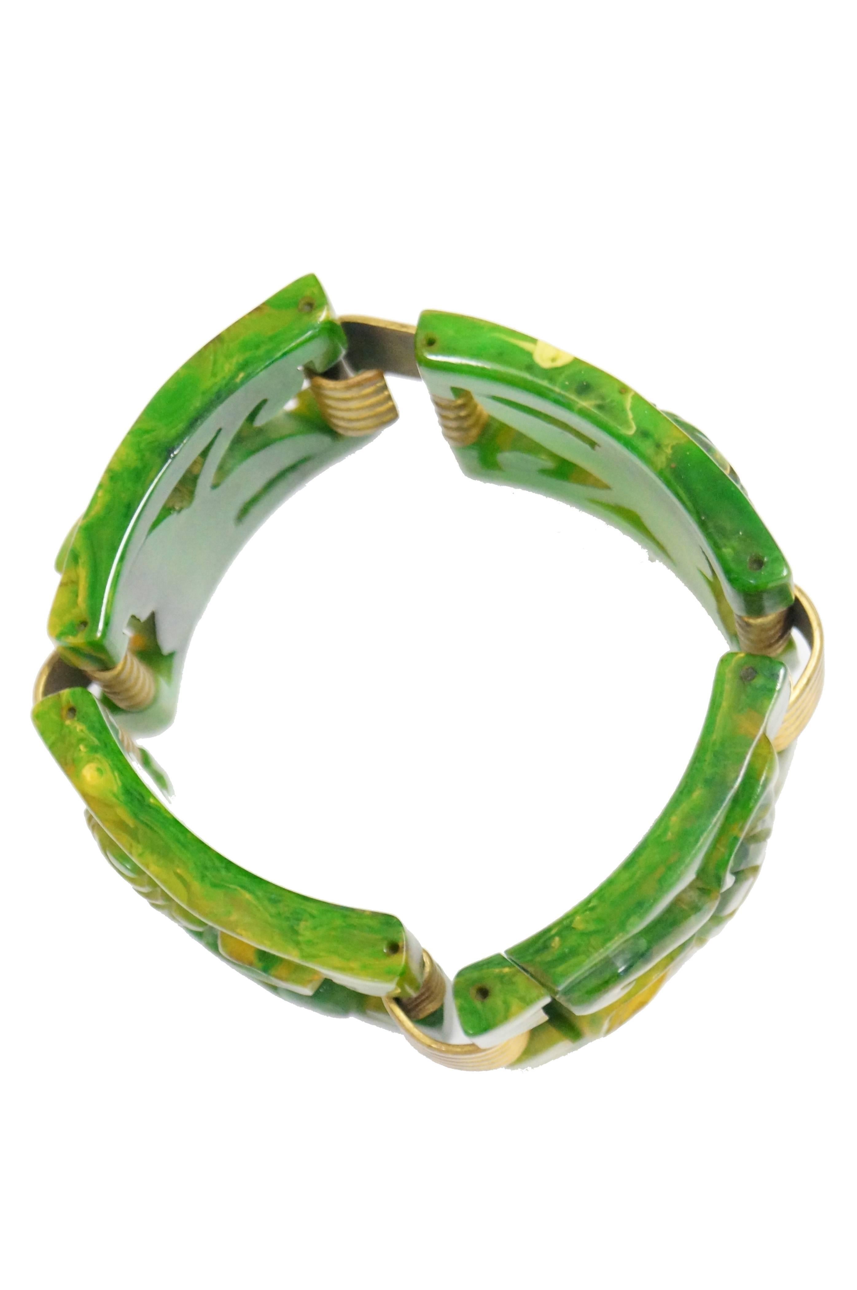 Fabulous heavy marbled green, gold, and clear book chain link bracelet. The bracelet is composed of four separate floral molded bakelite book-chain-like links held together by gold tone ridged hook links. The piece is almost 100 years old, and has