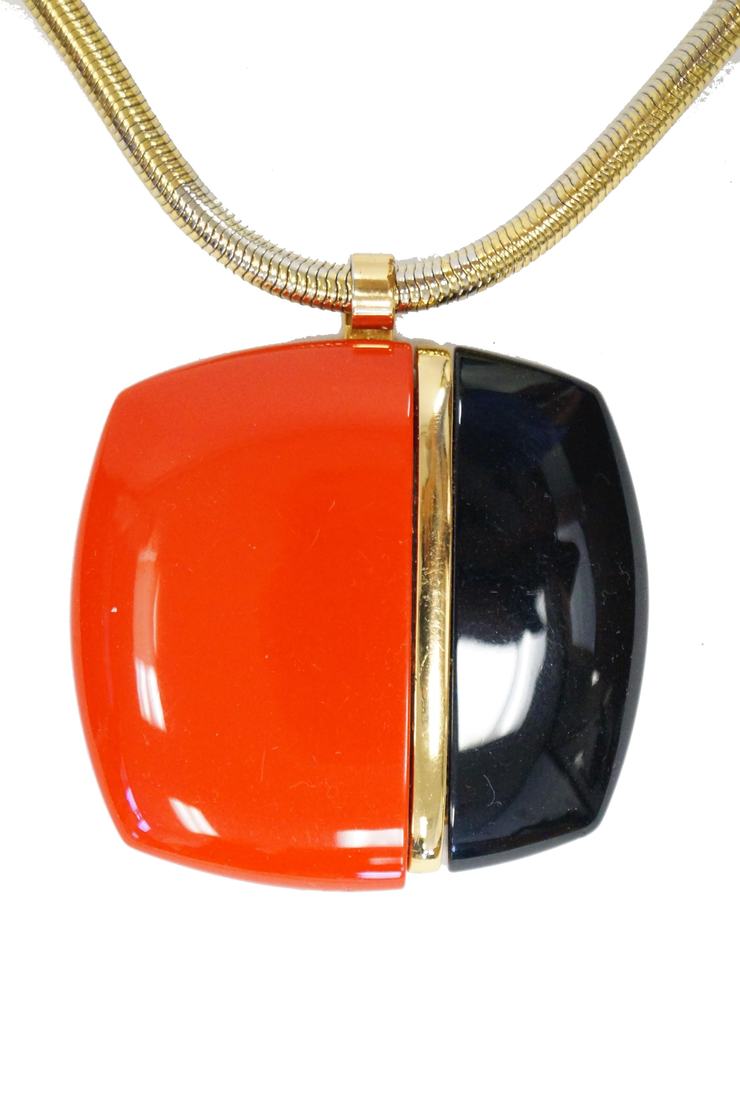 Fantastic red and black Lanvin of Paris oversized medallion necklace. The bold, rounded square pendant is composed of a two large rectangular lucite pieces (poppy red and black) with a gold - tone bar between the two. The pendant is strung on a