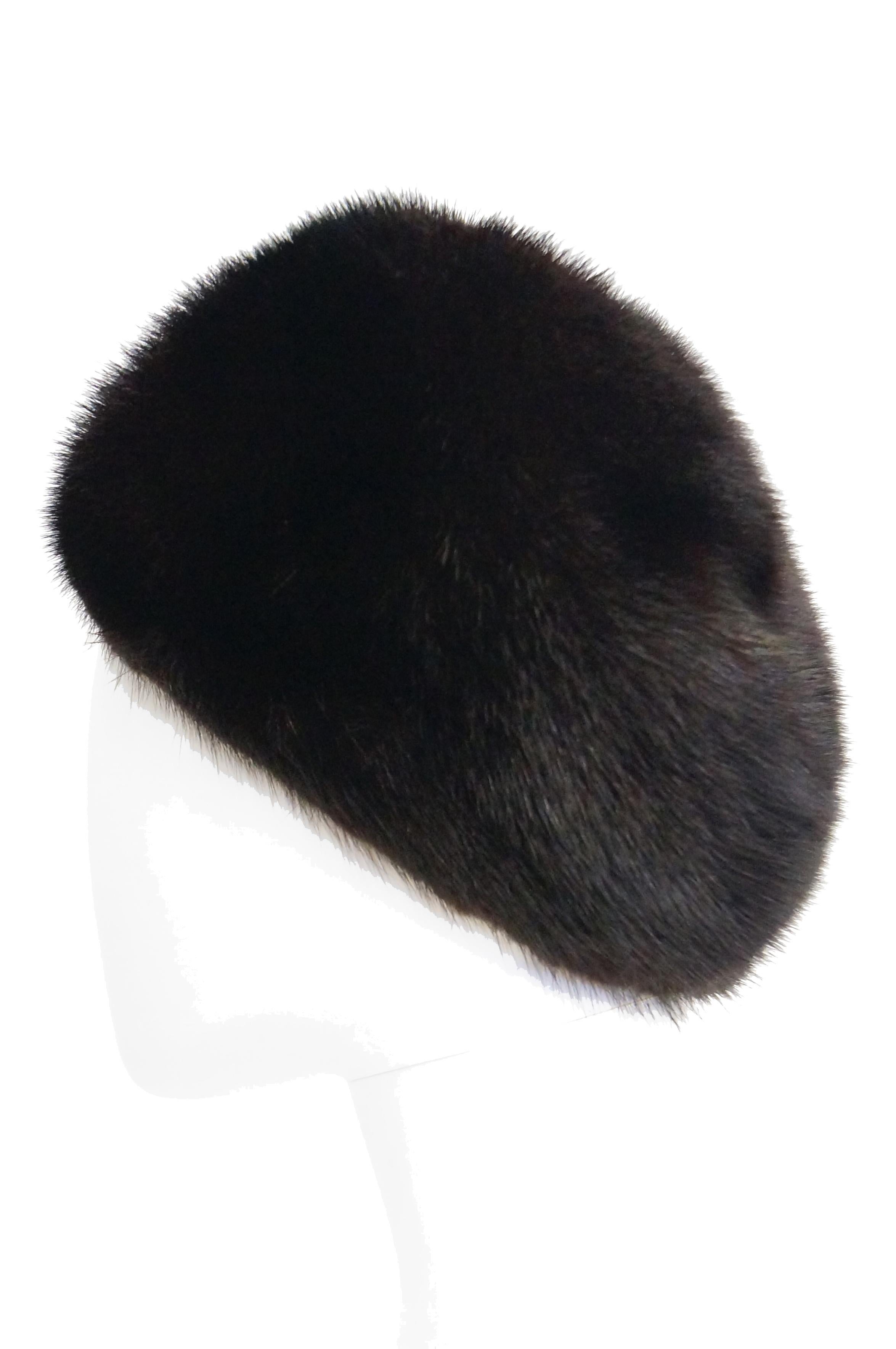 Beautiful dark espresso brown hat by Christian Dior Chapeaux. This mink hat has a rounded crown with gently sloping sides, long enough to keep the wearer's ears warm! Lined and features a grosgrain ribbon. The hat was sold at Marshall Fields'