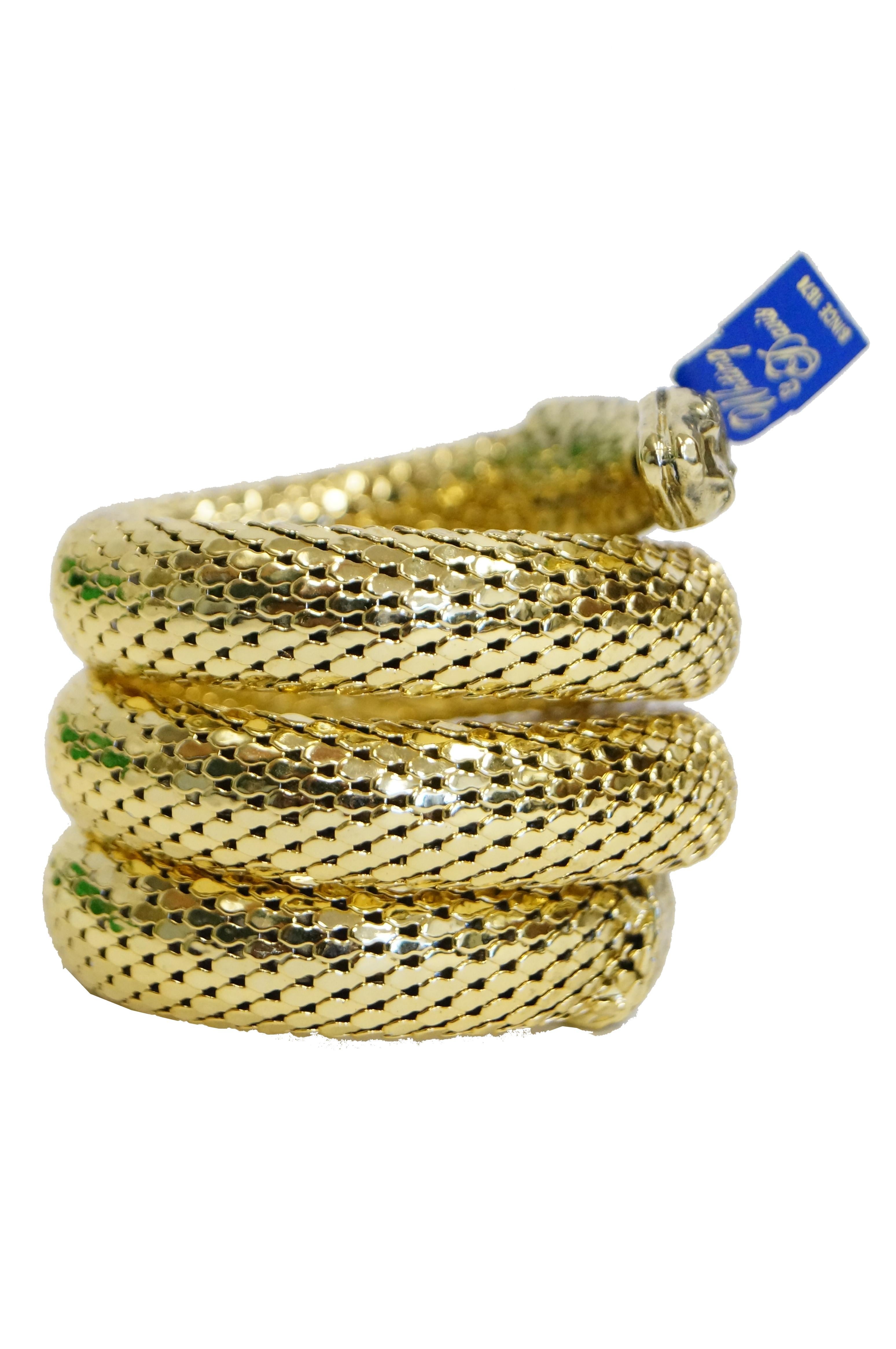 Amazing, new, old stock, gold tone, Whiting & Davis chain mail snake cuff! The snake cuff first appeared in the 1890s, and saw a great resurgence in the 1970s, with slinky materials such as chainmail dominating the disco nightclub scene. The snake