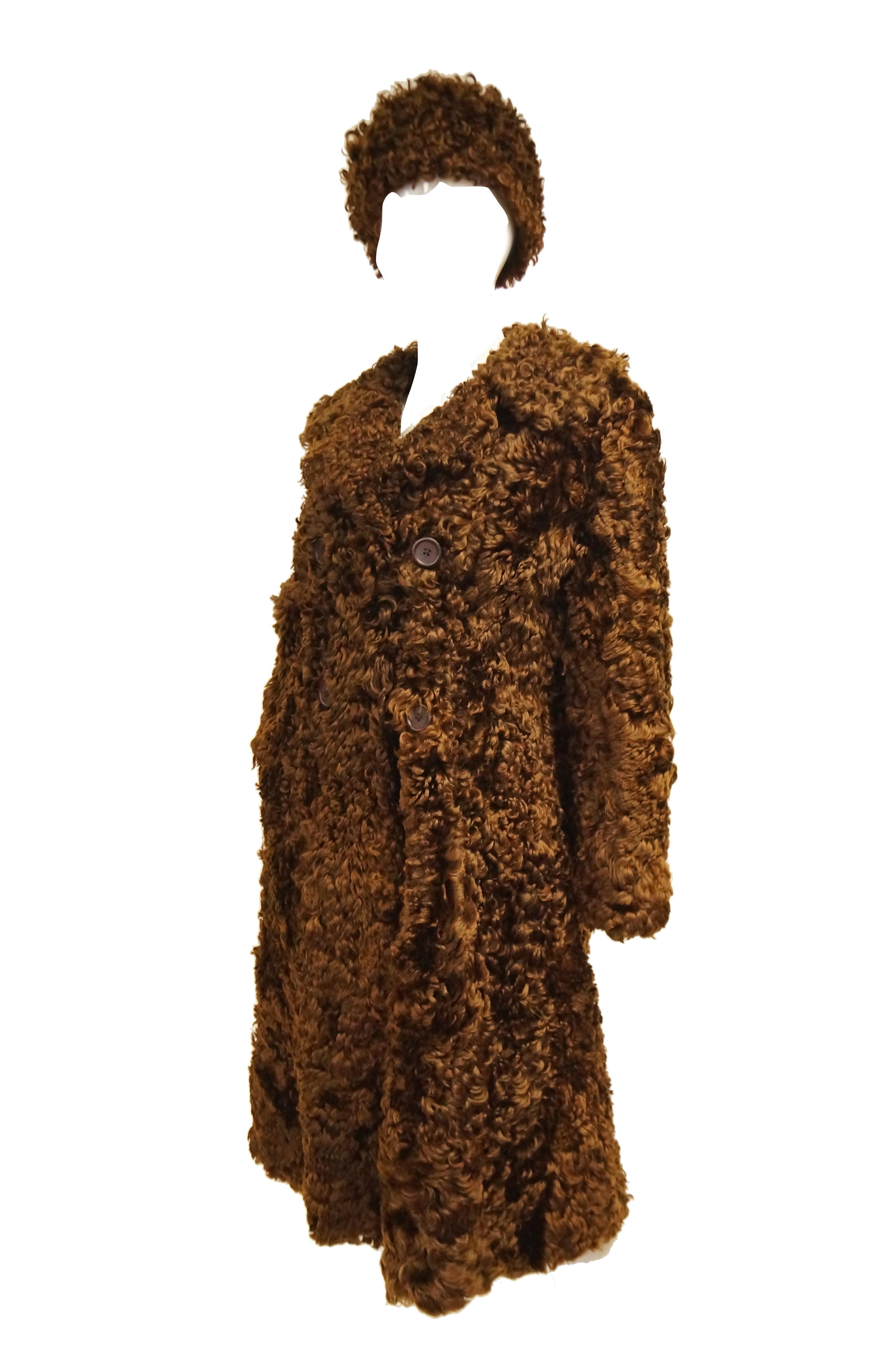 Love this! Adorable glossy brown curly lamb coat by Antarex of Scotland. The coat is knee length, with long sleeves, notched collar, and is double breasted with four buttons total. The coat comes with a matching pillbox hat! Bonus: pockets. 