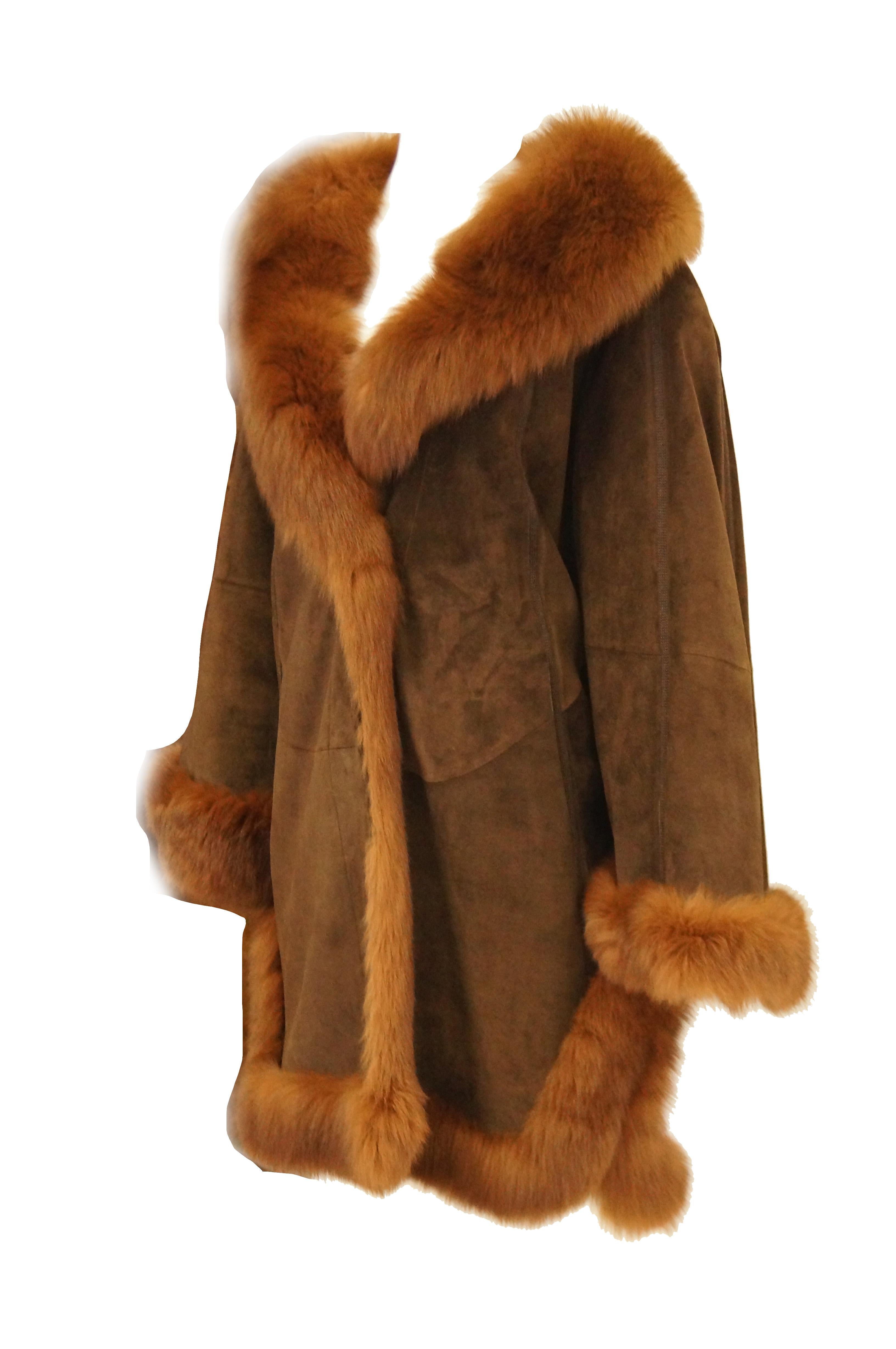 Too amazing! Loosely fitting suede coat with fox trim and knitted lining! The coat has a triangular silhouette with wide sleeves, a luxuriously plush shawl collar. The coat has a bit of a swing silhouette that's subverted with slits on the side. The