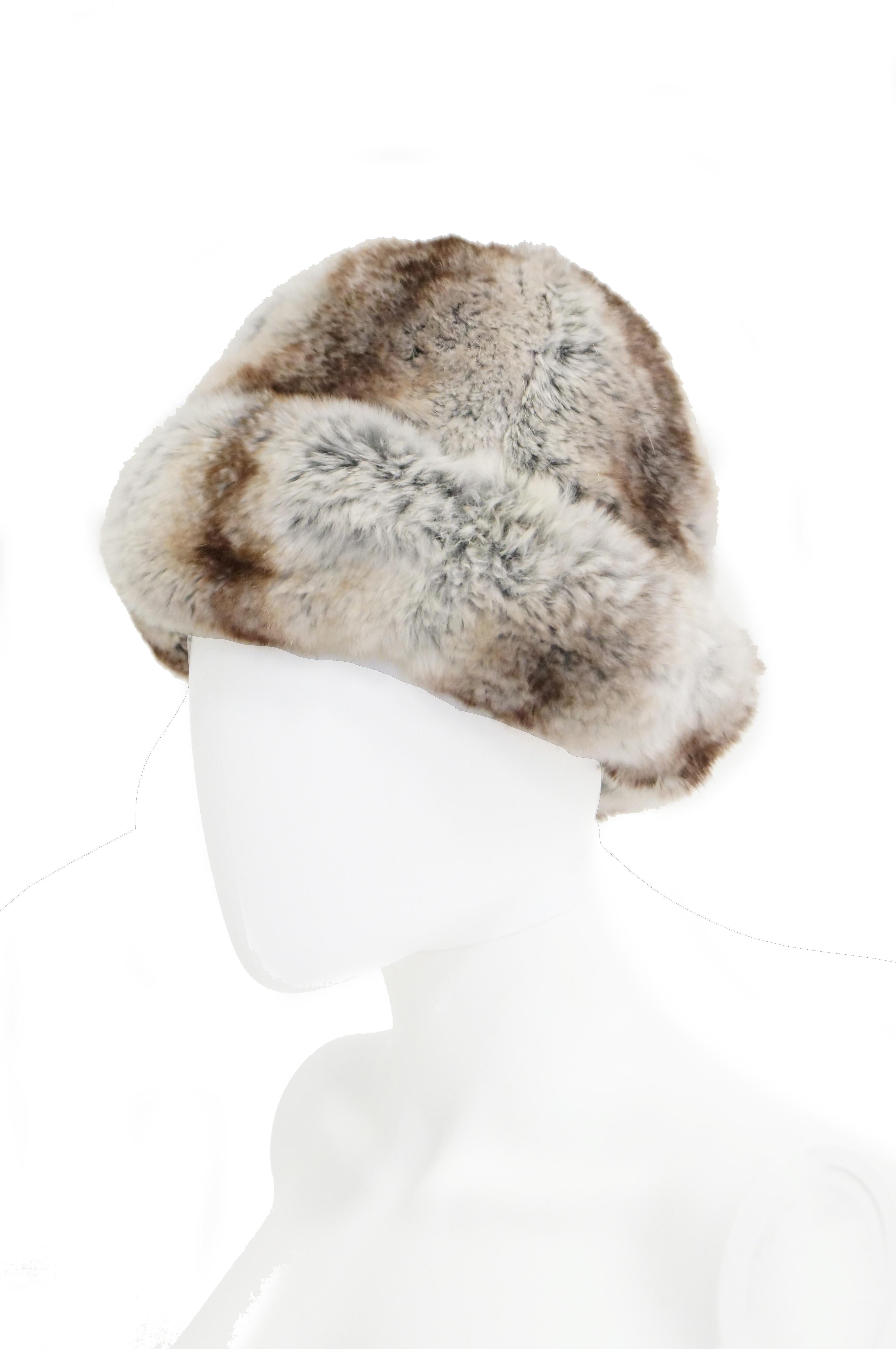 Beautiful plush grey, brown, and black hat by Christian Dior Chapeaux. This chinchilla hat has a rounded crown with gently sloping sides, and a brim that curls up at a steep angle! The brim can be pulled down slightly to expose a thick marled grey