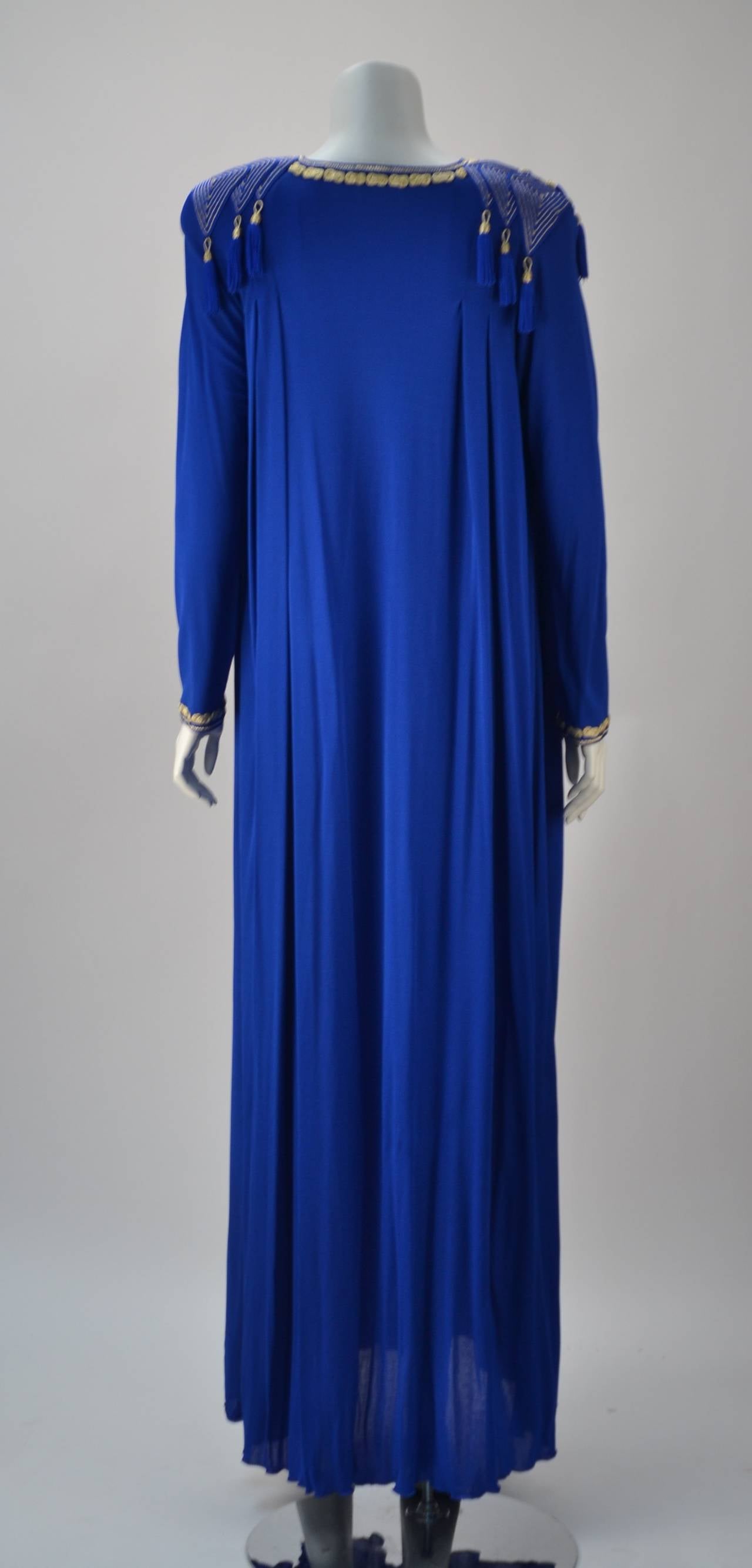 Absolutely beautiful royal blue knit caftan made in Morocco by Kenza!  Rich golden metallic detailing around neckline, shoulders and cuffs.  Gold and blue tassels hang in front and back of shoulder seam framing the dress and body. Perfectly placed