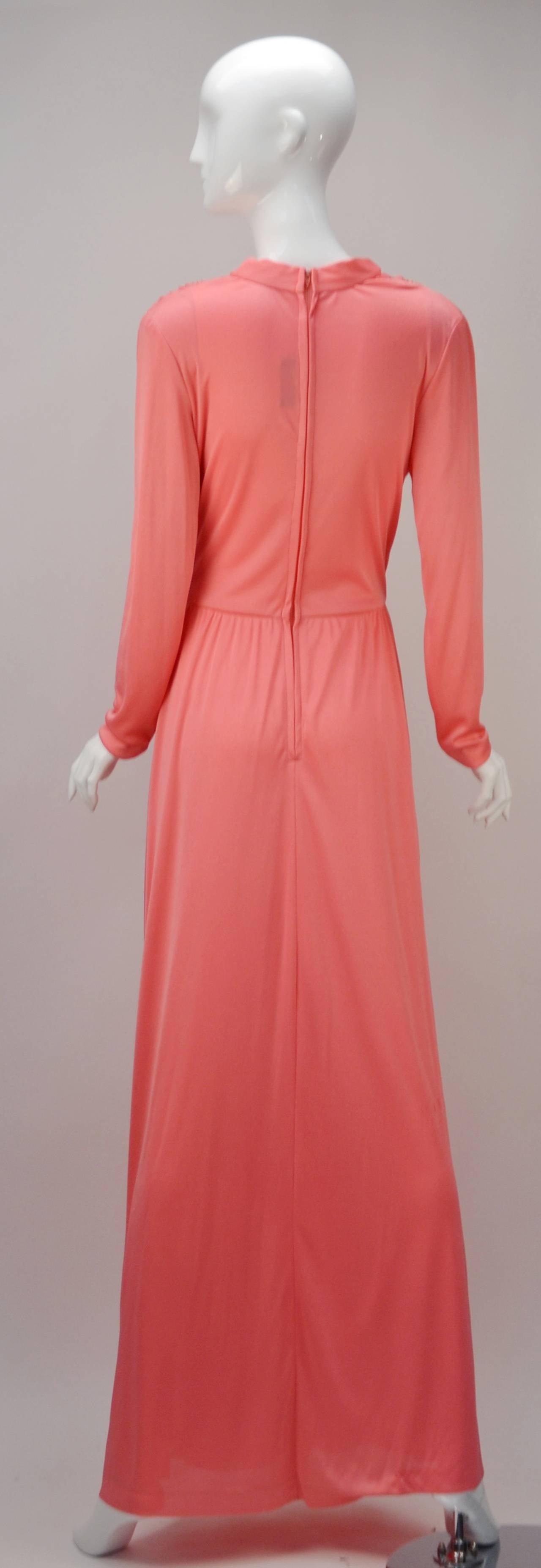 (Photographs Coral) 
Uber sexy vintage Joy Stevens of California knit wrap dress. Long and flowing with gathers at shoulder seams highlight all of the right curves.  Wrap front bodice and skirt are stabilized at bodice side seam. Wrap skirt opens