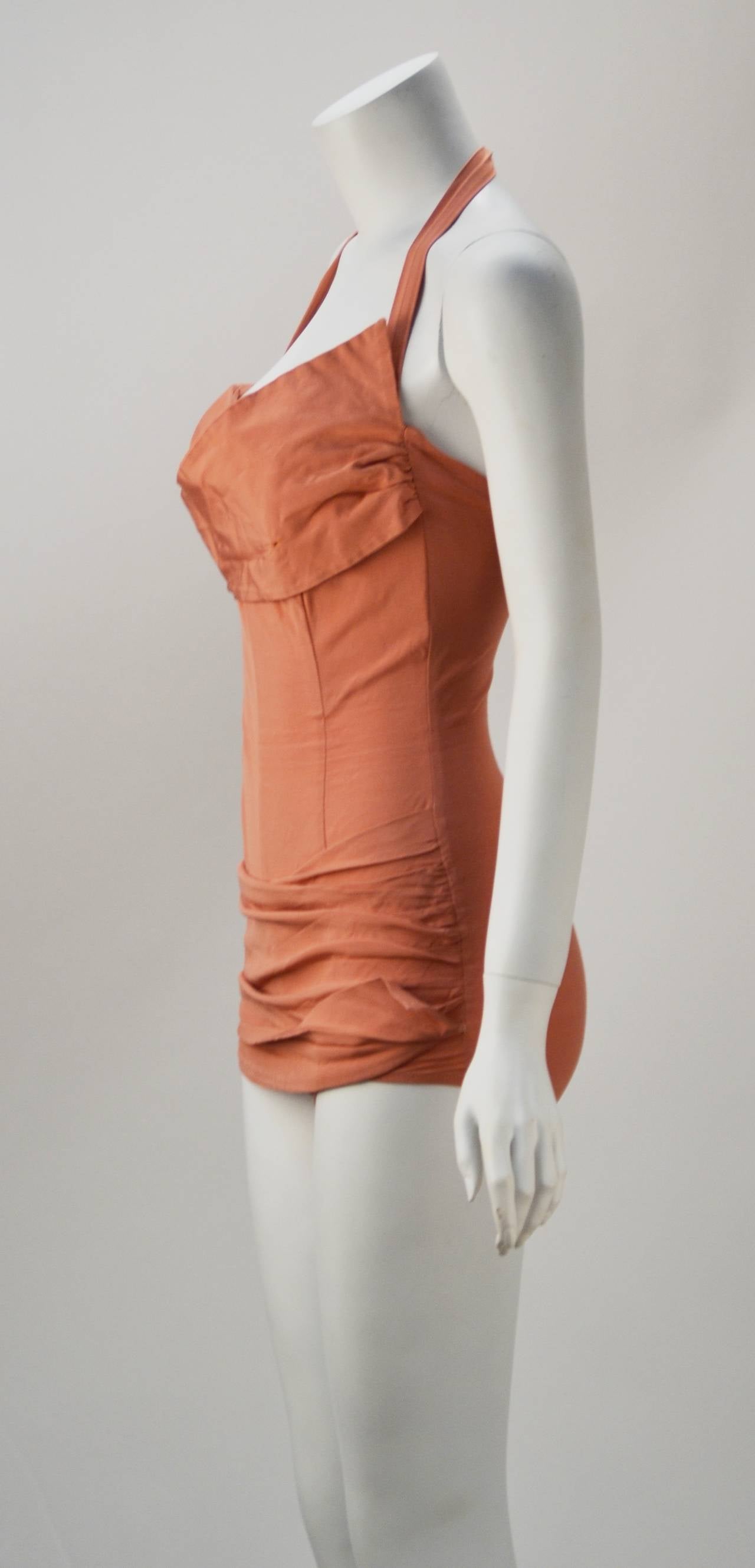 Fred Cole was known for his sexy Hollywood swimsuit designs. In the mid 50's he made swimsuits for Dior. This coral swim suit has an interesting Asymmetrical bust line and ruching across the hips along with lite boning along the princess seams. It