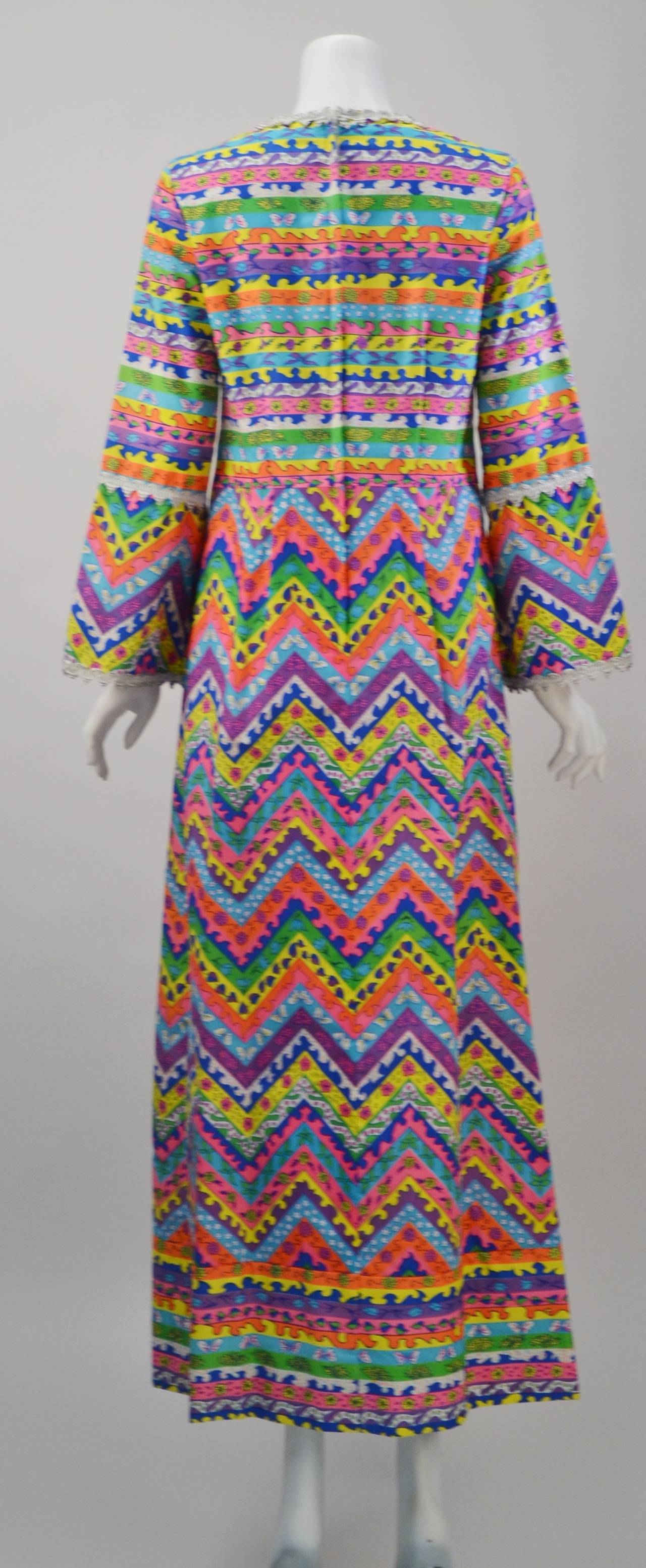Amazing and extremely rare caftan is a must this summer!  You will definitely have a good time in the piece -- it is so much fun!  In beloved Pulitzer colors, this cotton resort wear maxi dress is striped, zigzagged and embellished with rickrack. 