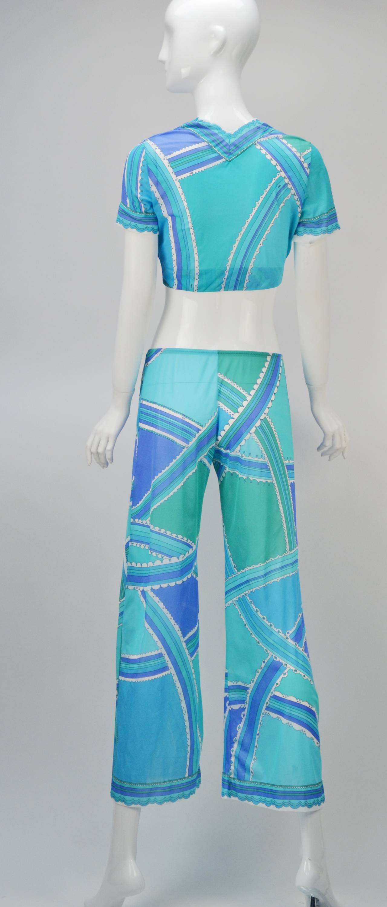 Beautiful and vibrant Emilio Pucci for Formfit Rodgers nylon top and pants two-piece lounge set. The short-sleeve top can be worn loose or tied in a crop format. The pants have an elastic waistband and flared leg. The "Pucci" logo can be
