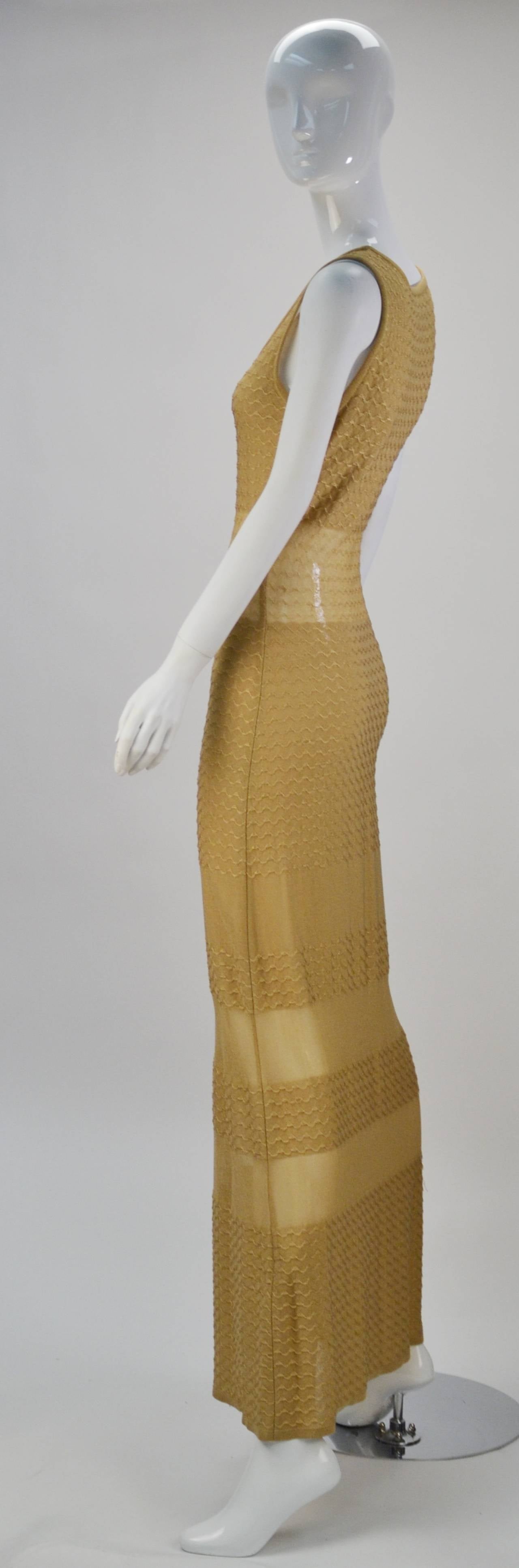 Gorgeous Fendi gold sheer panel knit dress is perfect for this summer and can be worn into fall with any skin toned slip.  Made of beautiful textured knit in gold the dress contours the body in just the right places. The color, shape and weight of