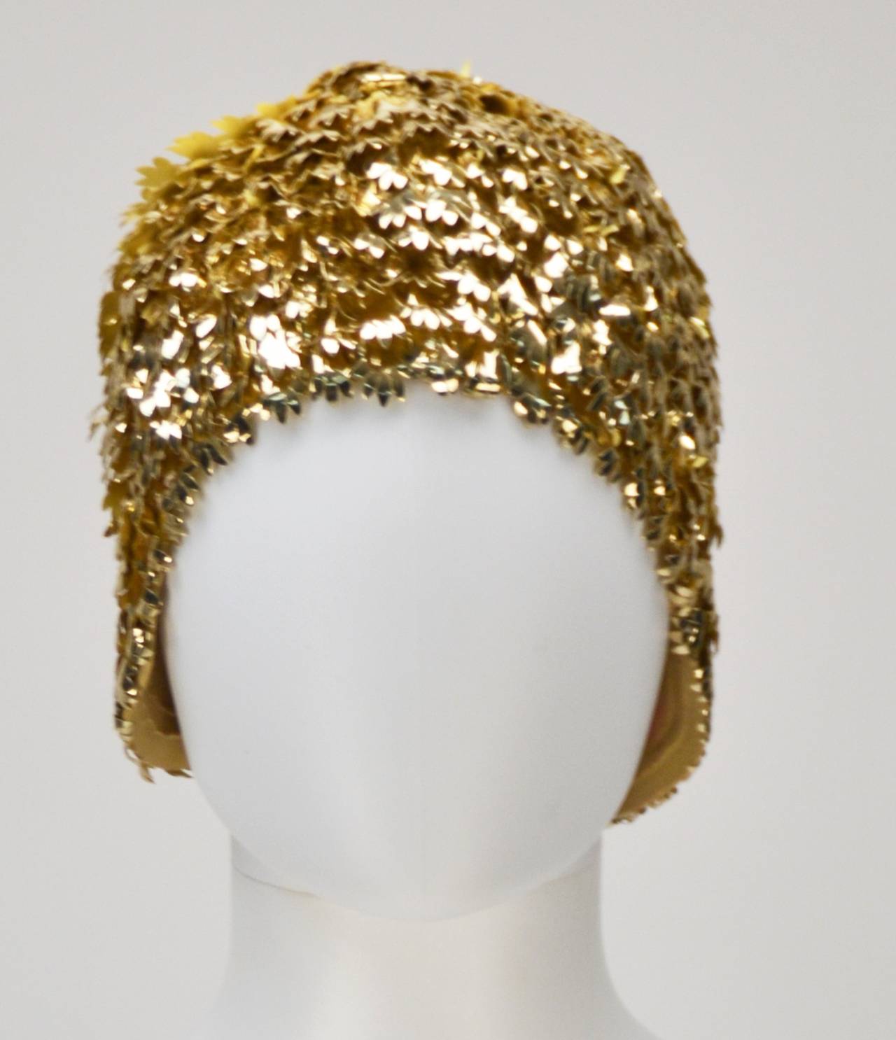 Stunning 60's -70's mod gold layered swim cap or avant-garde cloche made in Great Britain. The interioir of cap is rubber or latex. The exterior is almost tinsel-like and takes on a gorgeous layered leafy look.  Great to hide a bad hair day, for a