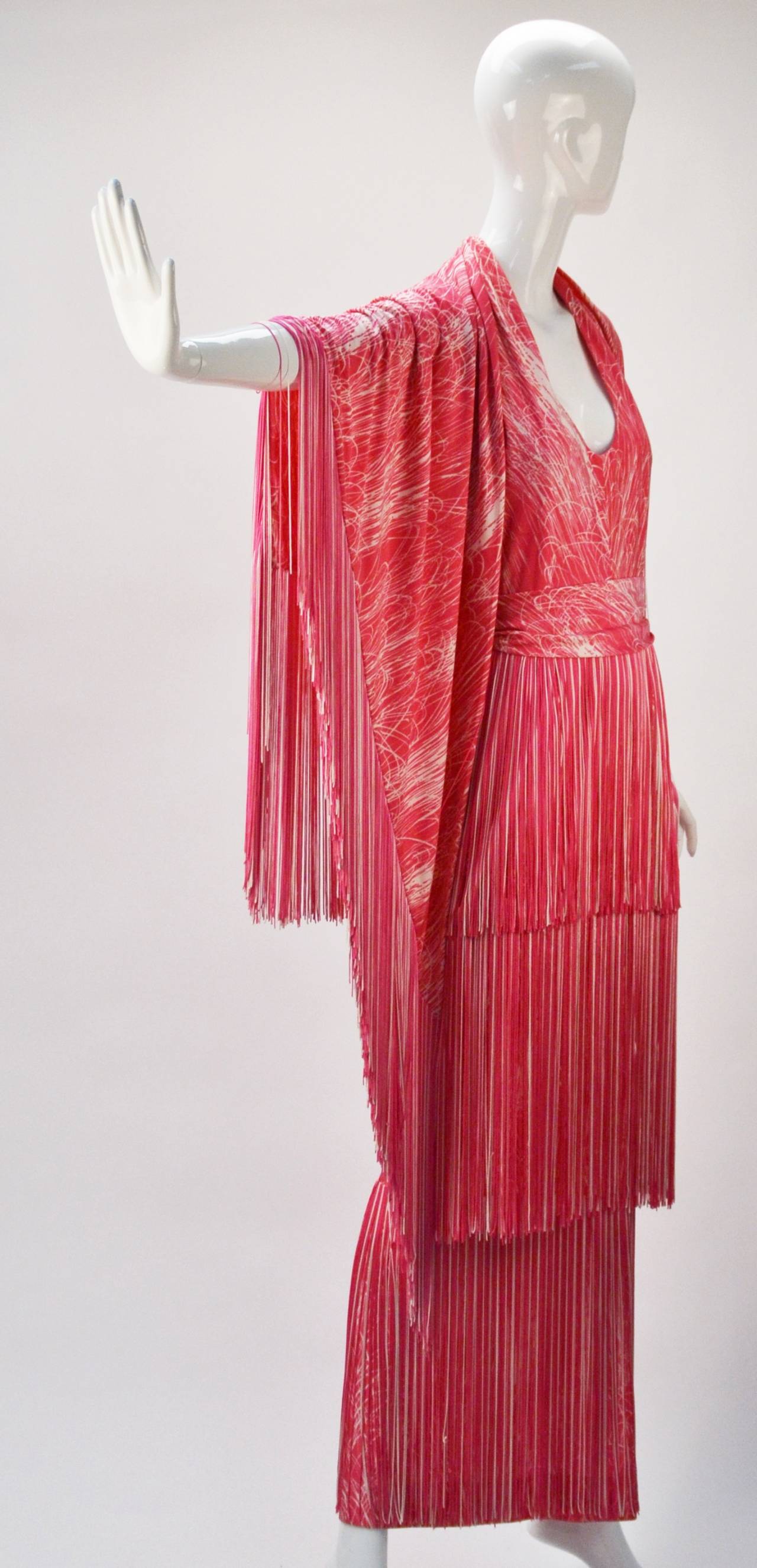 Sexy, stunning, and fun 1970's Lilli Diamond pink and white halter dress and shawl with fringe trim.  The halter neckline fastens at back neck with two hook-and-eyes, while also having a zipper fastener down the center back. There is a detachable