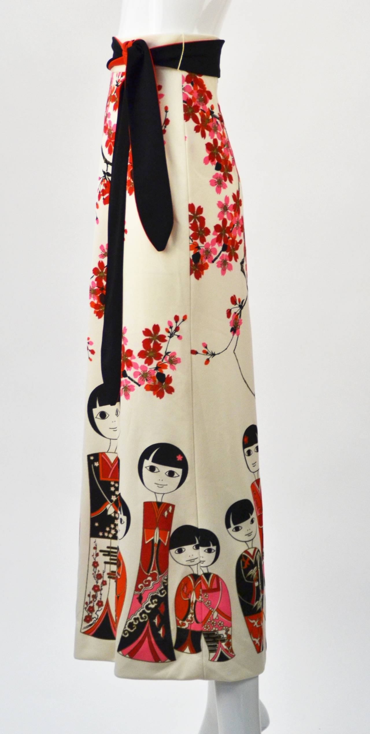 Fantastic 1960's print Miss Shaheen Japanese Kokeshi Doll border print maxi skirt with obi belt. Brilliant print by the master of Hawaiian print design, Alfred Shaheen.  The colors are vibrant and pop against the skirt's white background.  Shaheen's