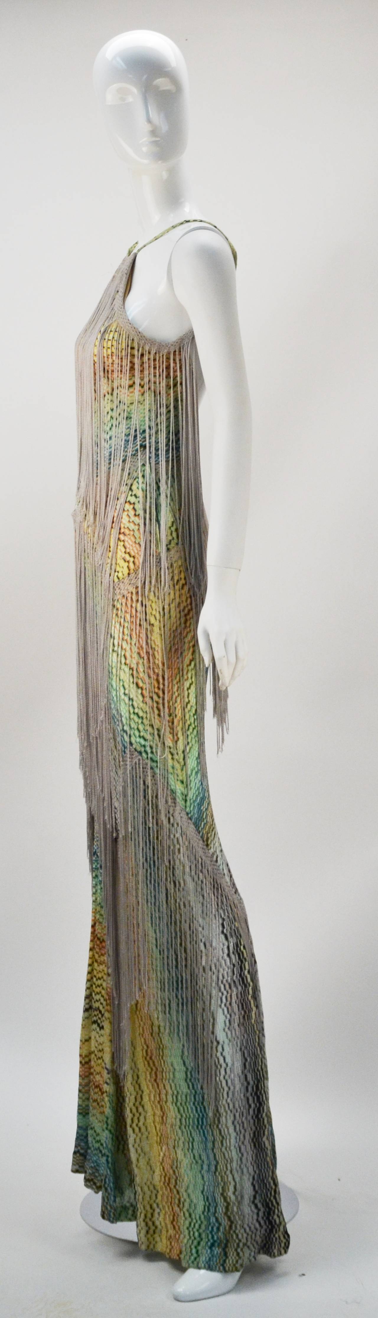 Iconic Missoni multi-color knit halter dress with exquisite fringe and crochet trim.  The bust of the dress is lined. There is a side zipper closure. The dress has a dramatic 71