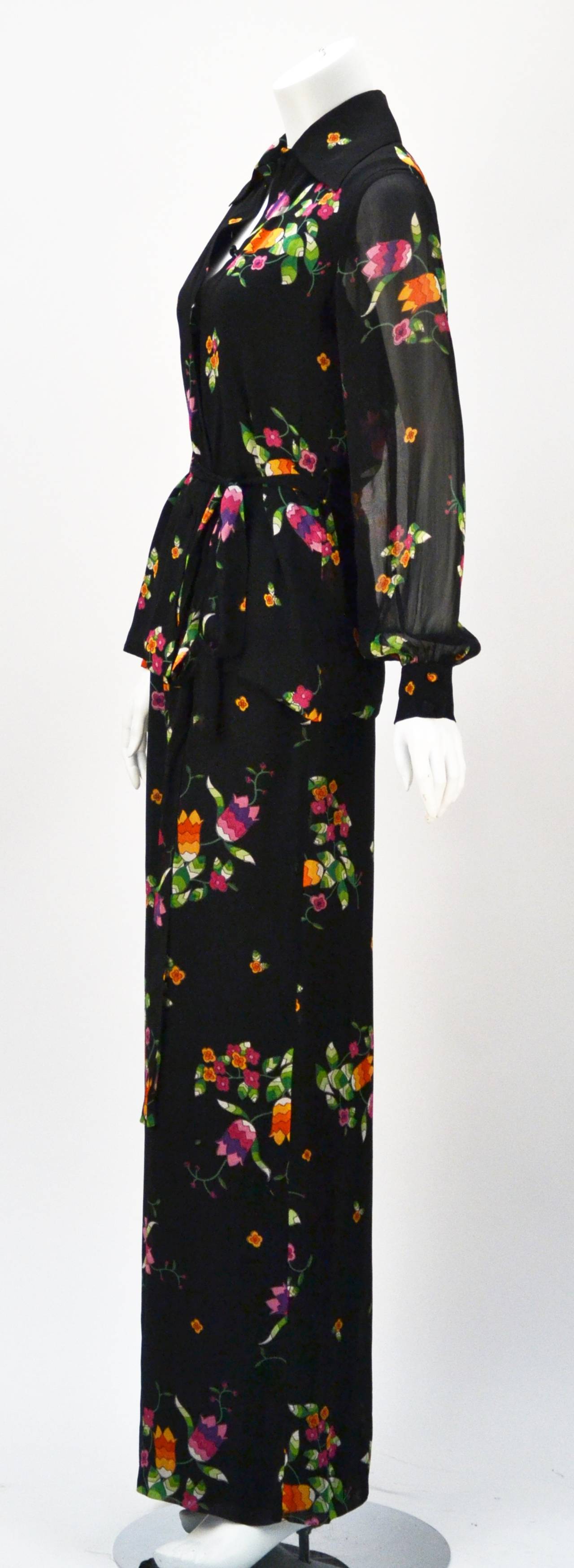 Chic 1970's floral print blouse and pant ensemble by Rizkallah for Malcolm Starr.   Boast Elegance and feel total comfort while wearing this outfit made in Italy. 

Ensemble boasts a collared blouse with sheer long, cuffed sleeves, and remaining