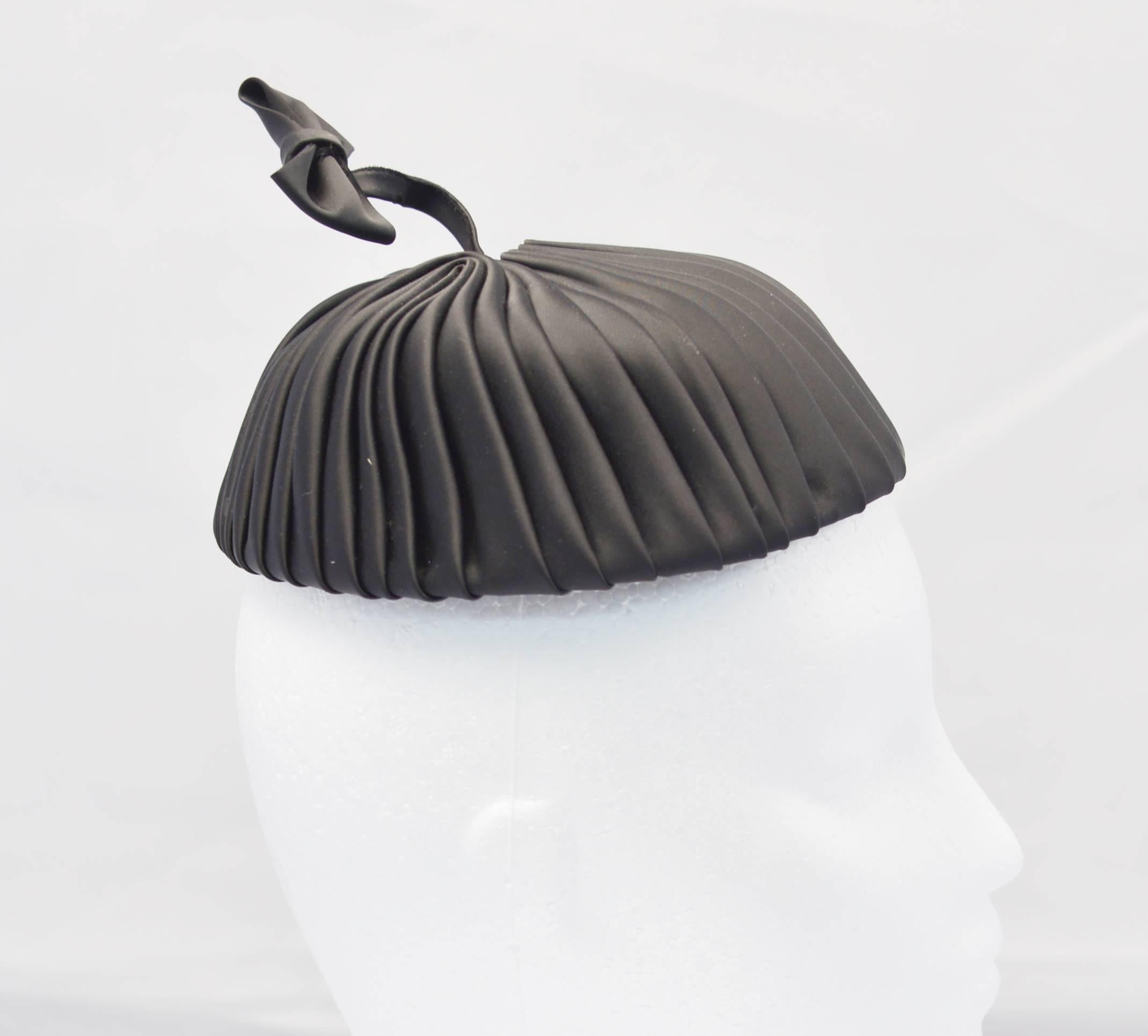 Fun and Fantastic, 1960's Miss Sally Victor black pleated pillbox style hat with springlike bow accent.  In excellent, possibly unworn condition.  Perfect for adding a bit of whimsy to your evening or adding a dash of drama to otherwise perfectly