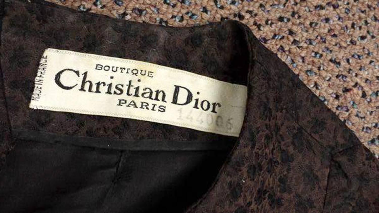 New Look Refined. 1950's Christian Dior dress in dark brown (#144006) with black floral motifs. Dress features elbow length sleeves with three fabric buttons and sweet bow at center front of the bust which adds a touch of femininity. The dress