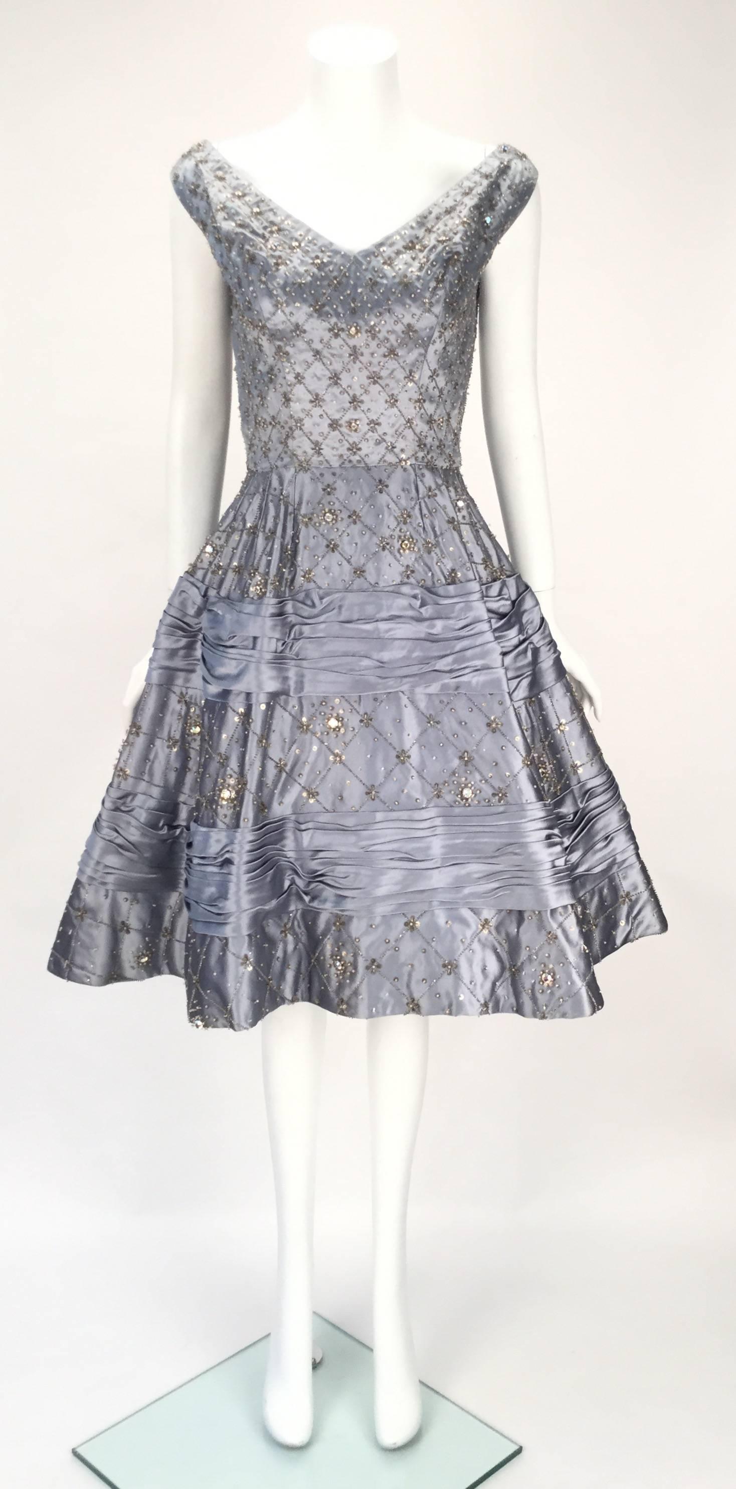 Remarkable 1950's dusty blue satin evening dress with iridescent rhinestone embellishment throughout. The full 
