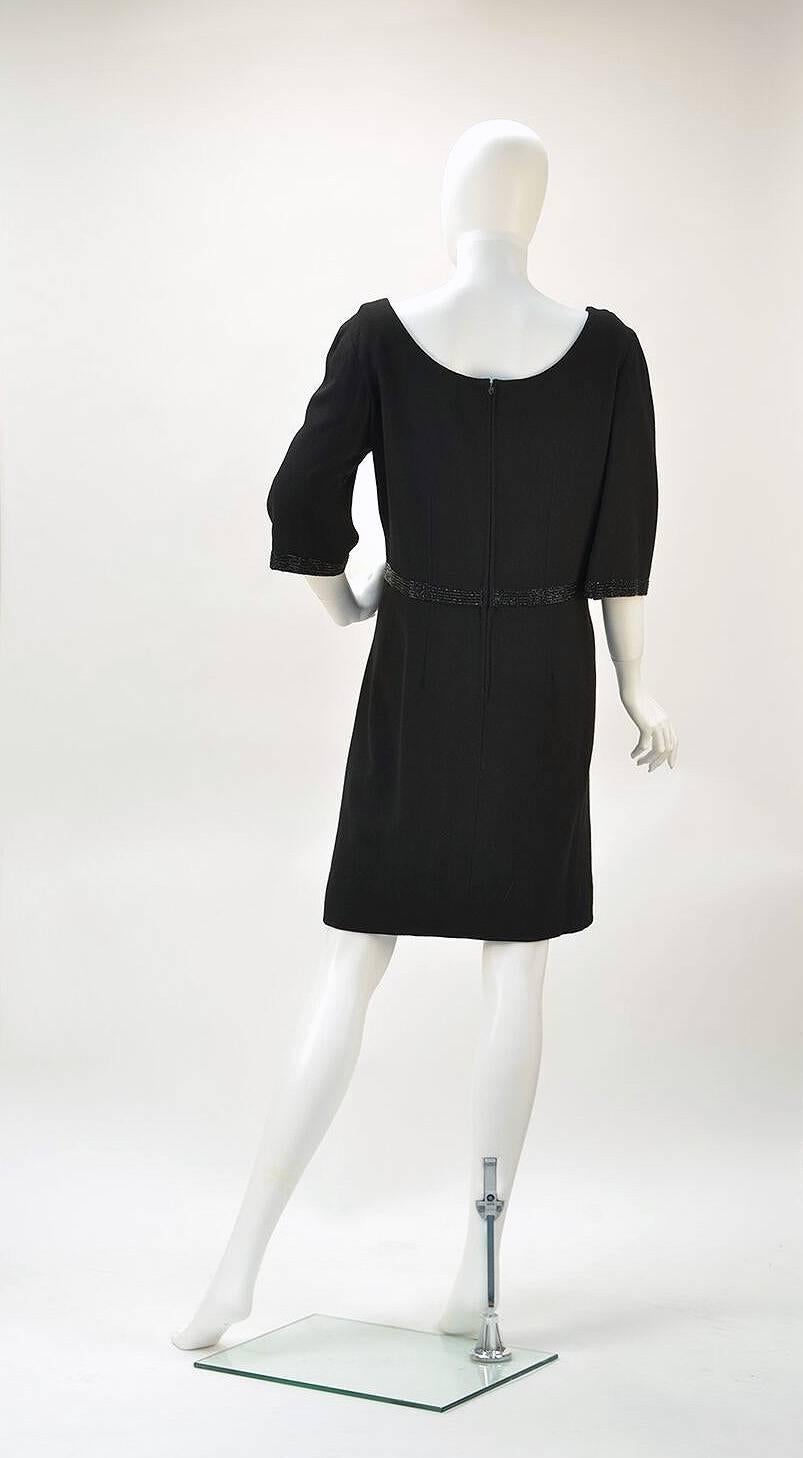 Couturier to the Royal family, the great Norman Hartnell designed this dress exclusively for Neiman Marcus, one of the first dresses to be made exclusively for the store by a British Couturier.

This perfectly designed black wool dress has deep