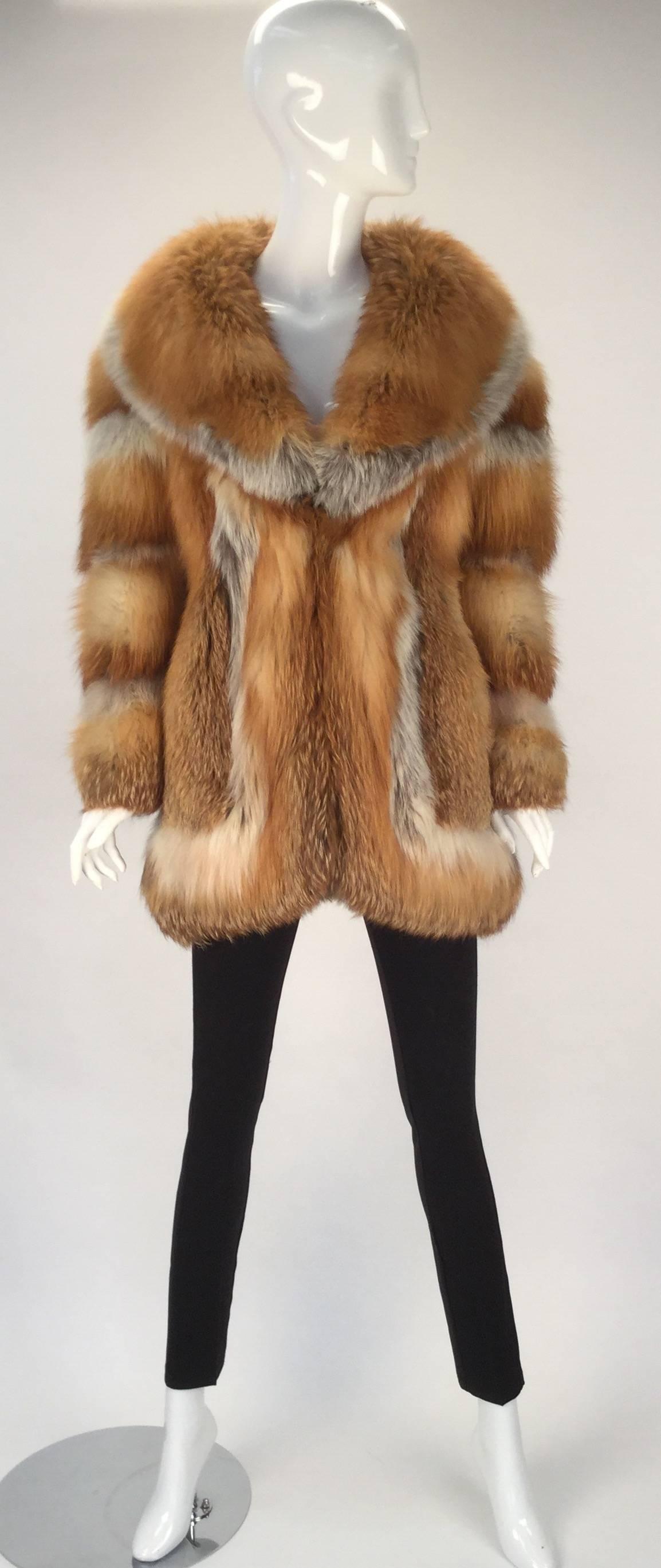 Awesome red fox fur coat with caramel colored leather panel on sleeves and under collar.  Stay warm and rock your 70's vibe in this perfectly preserved, stored coat.  Large fur collar and trim frames the piece as it travels from neck to and around