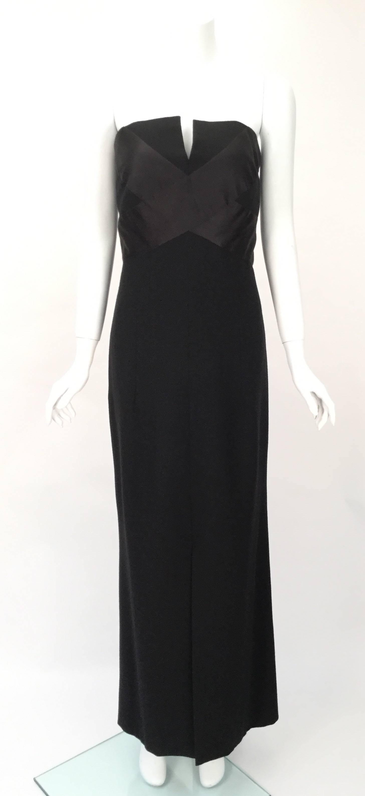 Elegant black Chanel evening dress. Constructed to flatter a full figured woman. The empire waist bodice has boning, soft wire cups, a spandex inner side back panel and a spandex inner mini skirt that covers past the hip line (built in designer