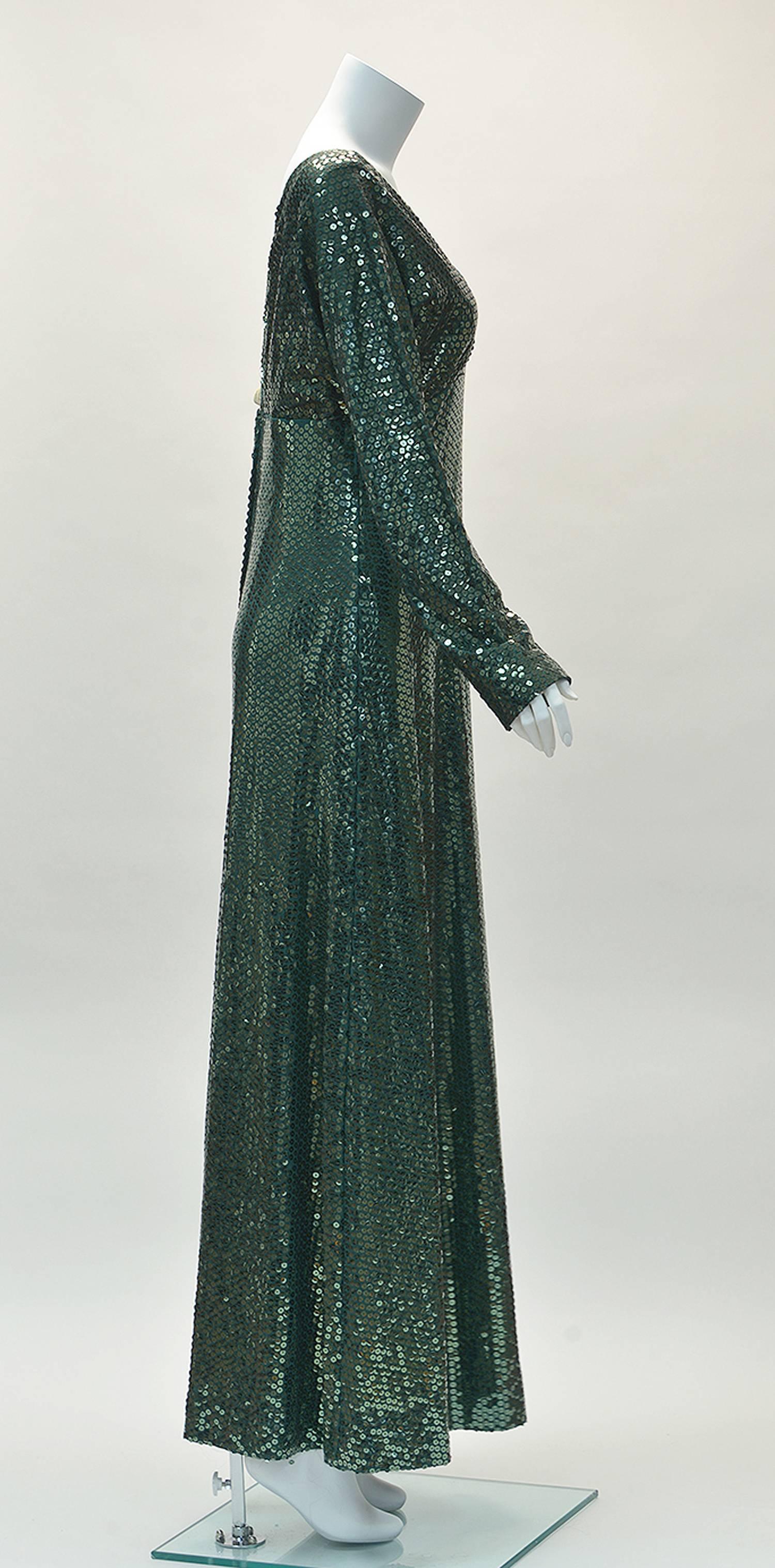 Kiki Hart was a designer in the 1960's who designed upscale garments. 
Her New York based design house was known for extremely detailed craftsmanship and high end fabrics.
 
This long green sequin knit dress twinkles in all the right places! Dress
