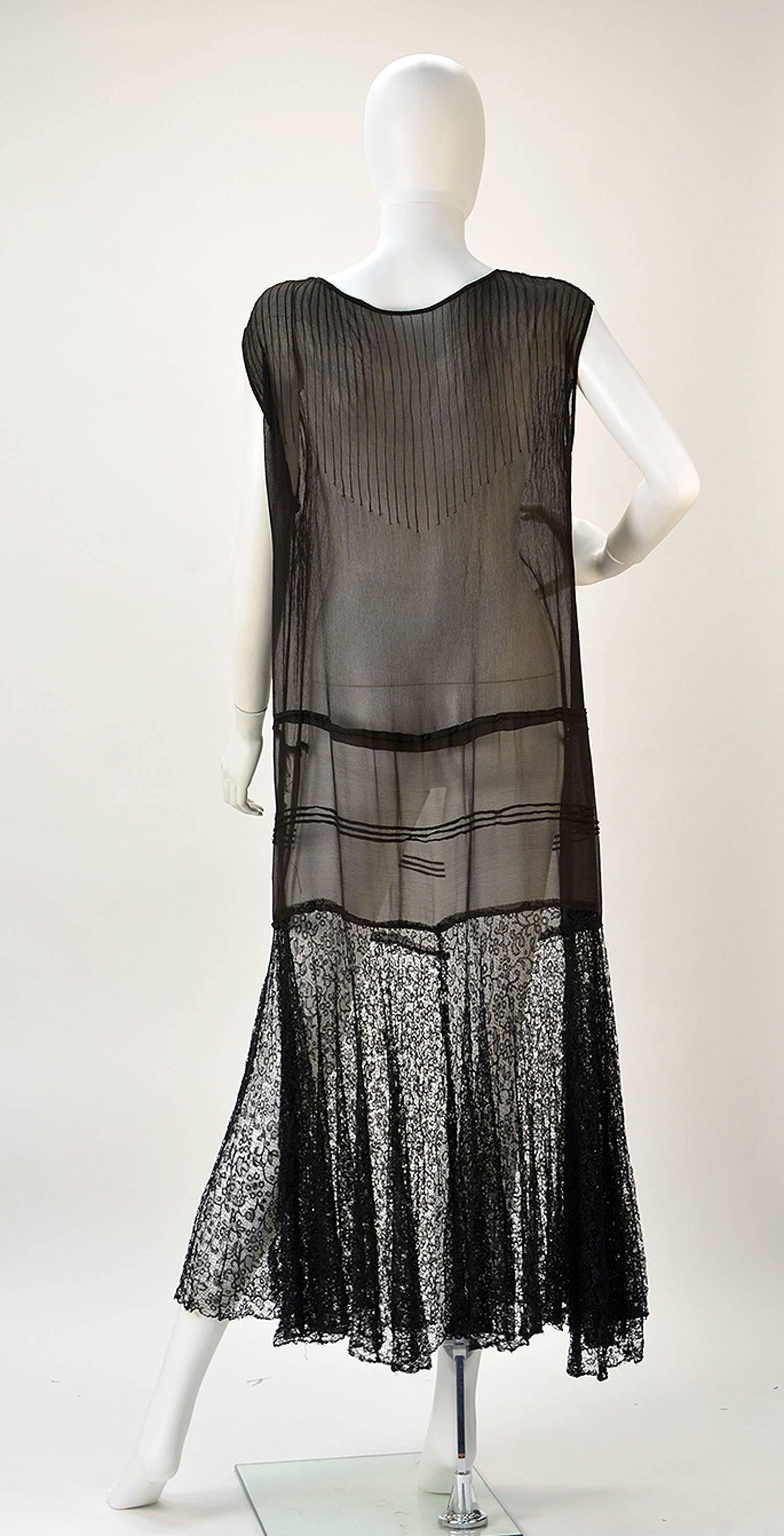 Delicate and wonderful, this sheer almost antique dress from the 1920's is a pure dream. 

Dress has stitching running from neck and shoulder to mid dress, mimicking pleats. One seam runs along the waist, while three run below it giving the dress