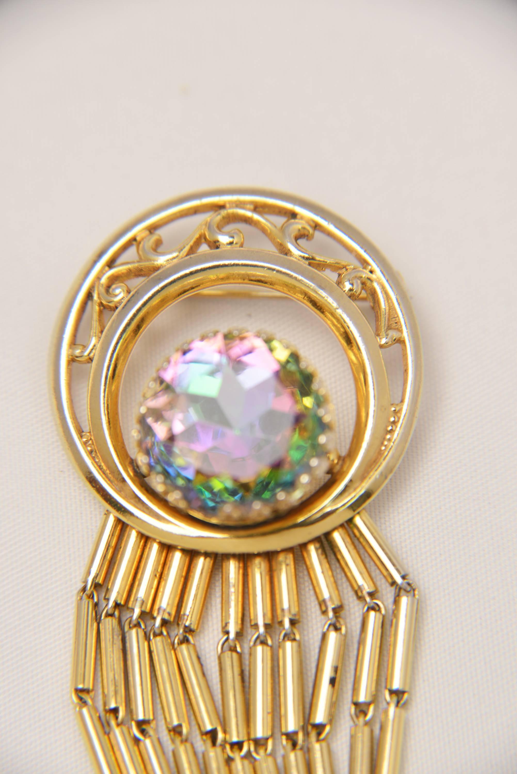 Fantastic watermelon tourmaline brooch. Designed by the iconic Elsa Schiaparelli who was friends with Salvador Dali. The asymmetrical gold metal bugle bead fringe hanging from a crescent moon shaped circle shows her humor as well as her 