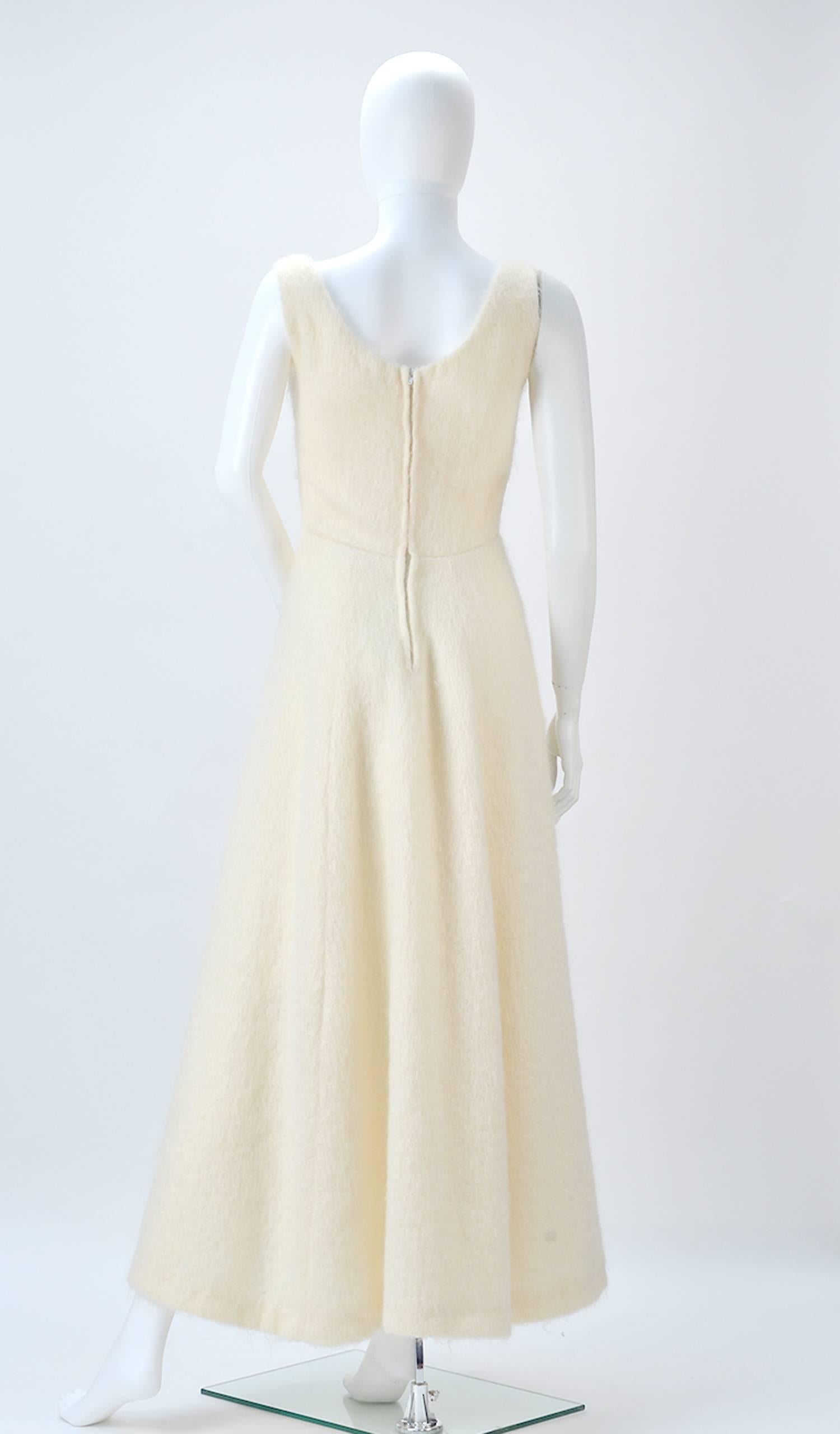 Gorgeous Winter White Mohair dress is simple luxury! An added bonus that it is warm and cozy as well! Fitted bodice to hip-line flaring into an A-line skirt. Making the silhouette a fit and flare. A blank pallet to style any way you wish. Zips at