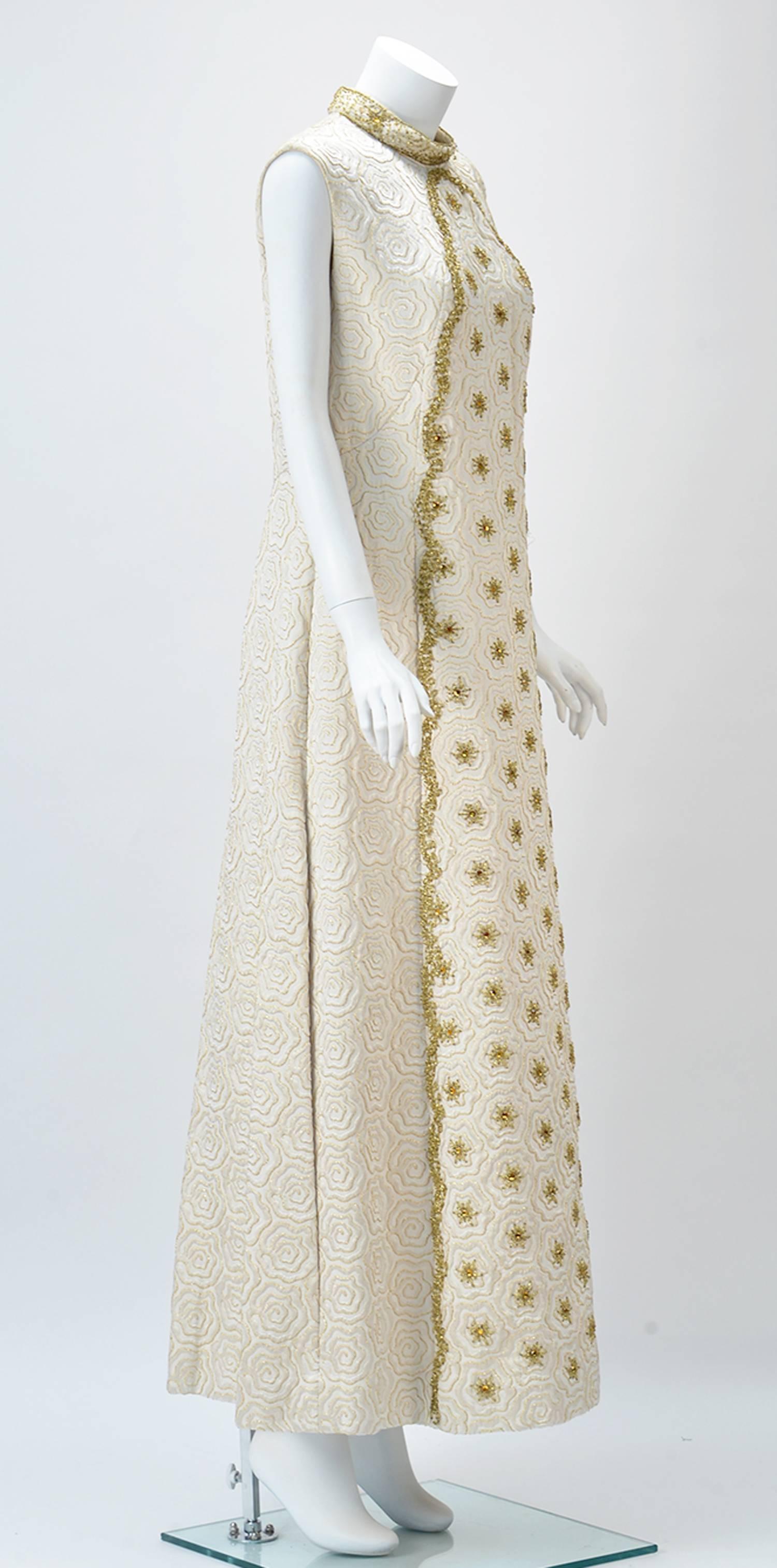 Daring and Different this holiday?

This is it....Wonderful winter white jacquard maxi dress.  Beautiful gold beaded embellishment frames a stand up collar and the front of the dress.  The piece features a textured floral pattern outlined with gold