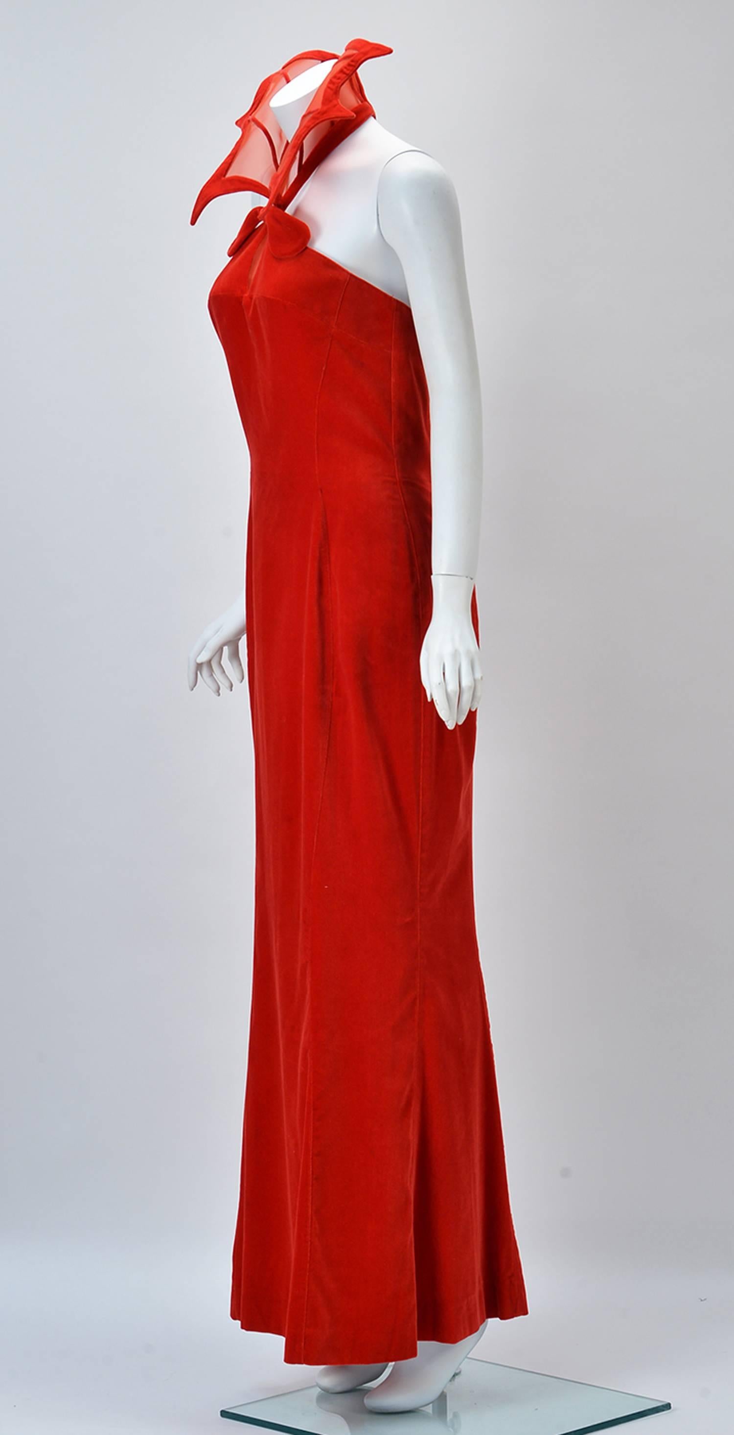 Rare and Outstanding 1980's "Kiss of the Spider-woman" gown by Thierry Mugler. Dramatic red velvet fit and flare stand up collar dress. Strapless with collar attaching at front neck and velvet covered snaps at neck back. Red net keyhole at